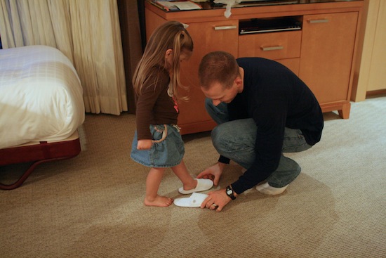 Gordon helping Brooke put on slippers