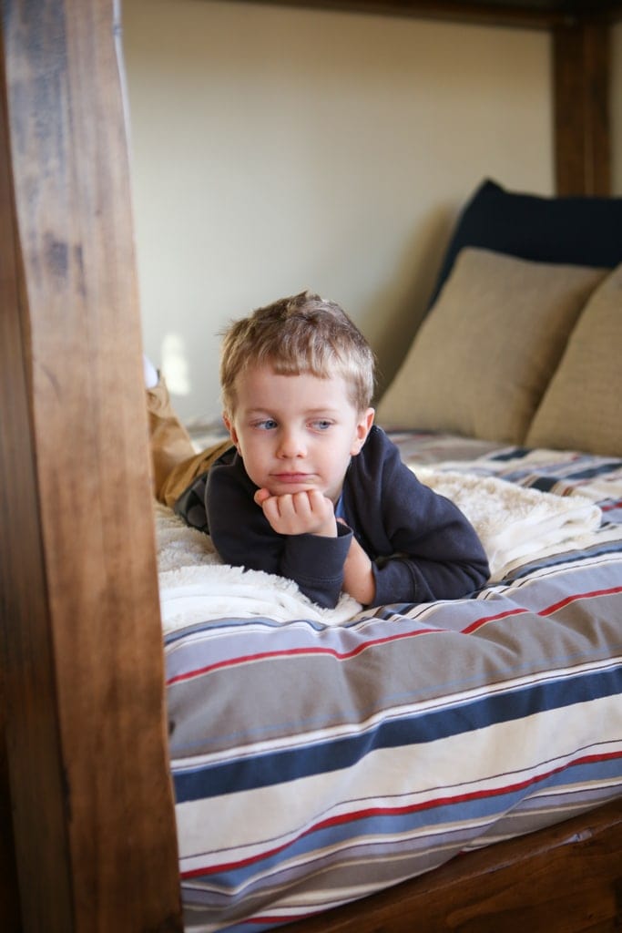 A boy laying on a bed