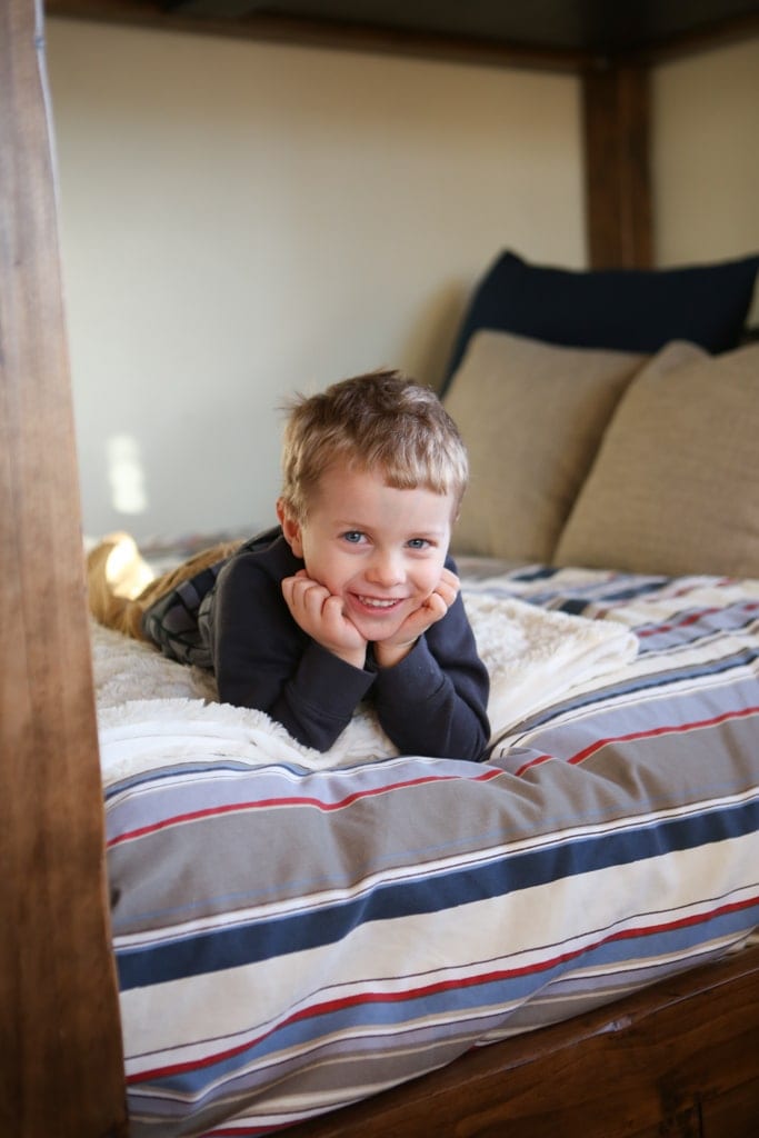 A small child laying on a bed