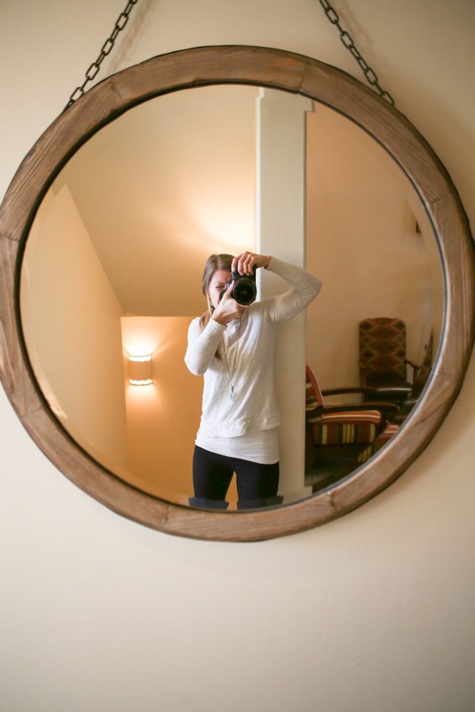 A person standing in front of a mirror posing for the camera