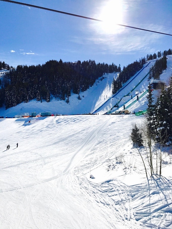 A man riding skis down a snow covered slope