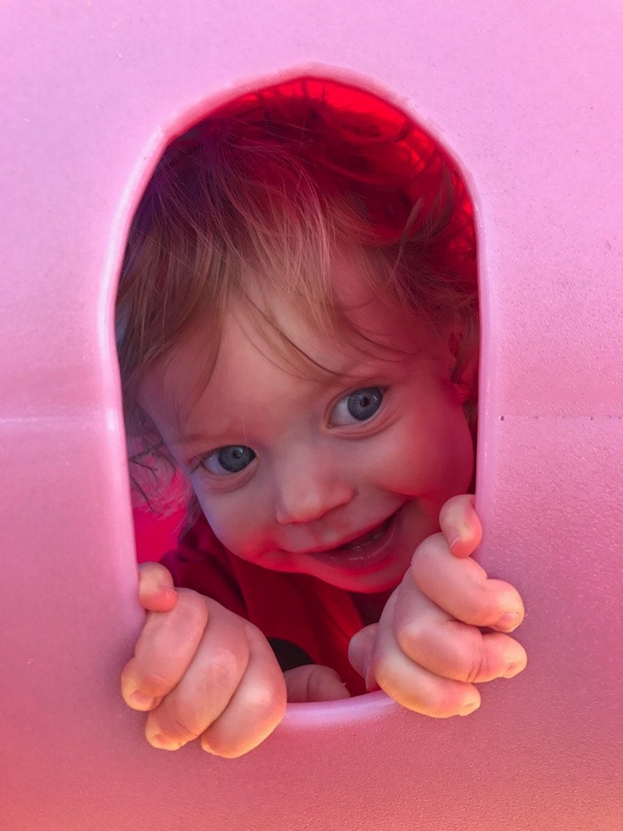 Eddie peaking through a play structure