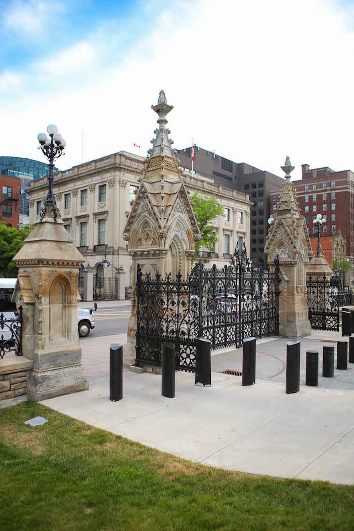 A gate with buildings behind it