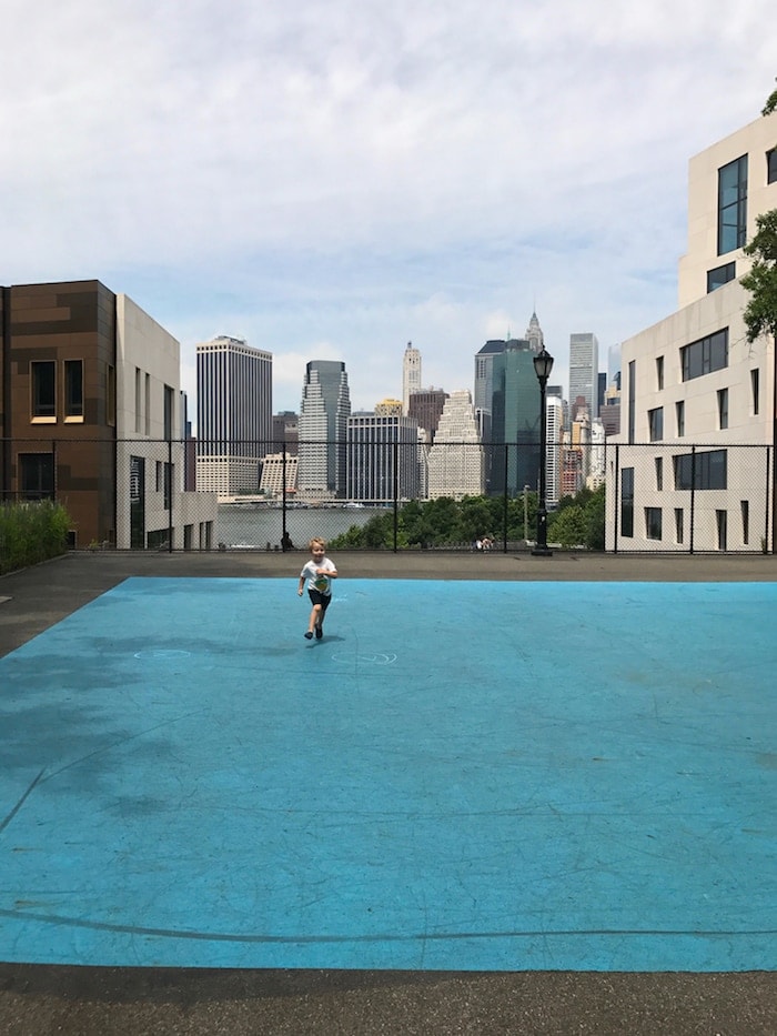 Blake running with a city in the background