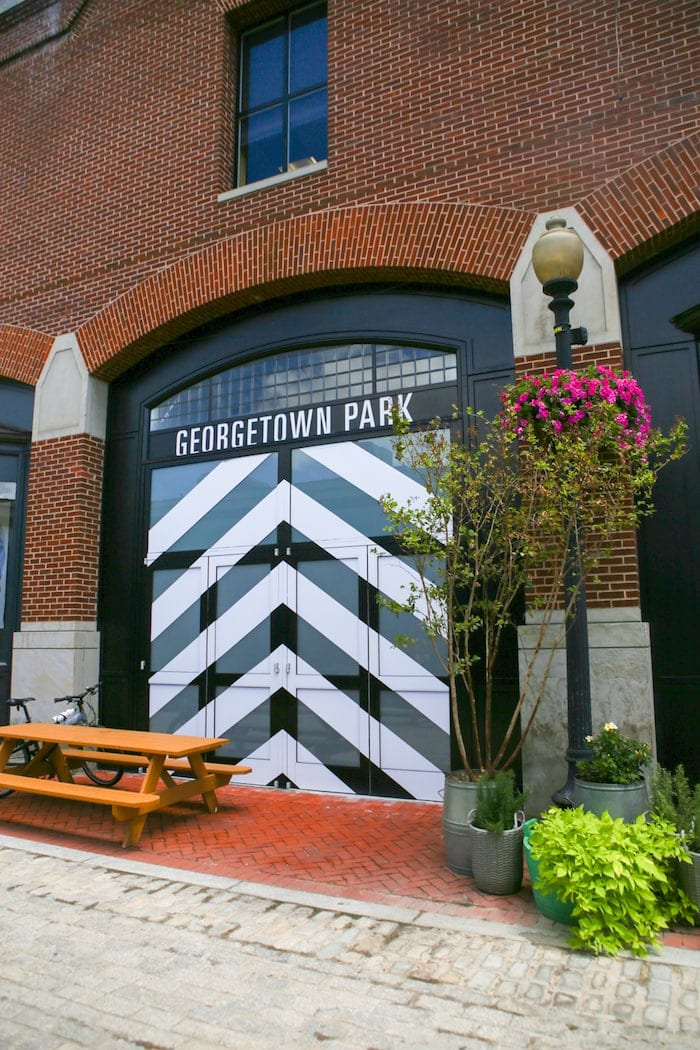 A sign in front of a brick building