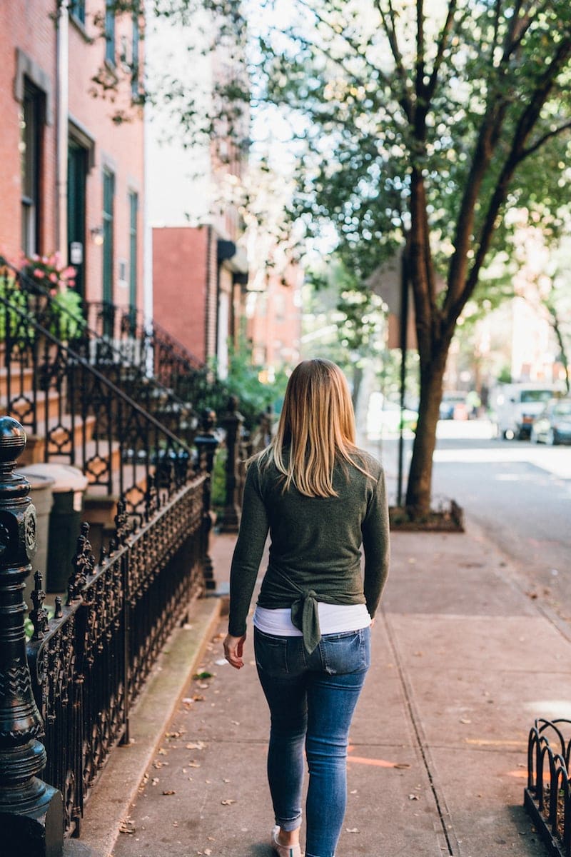 Lauren walking down a sidewalk