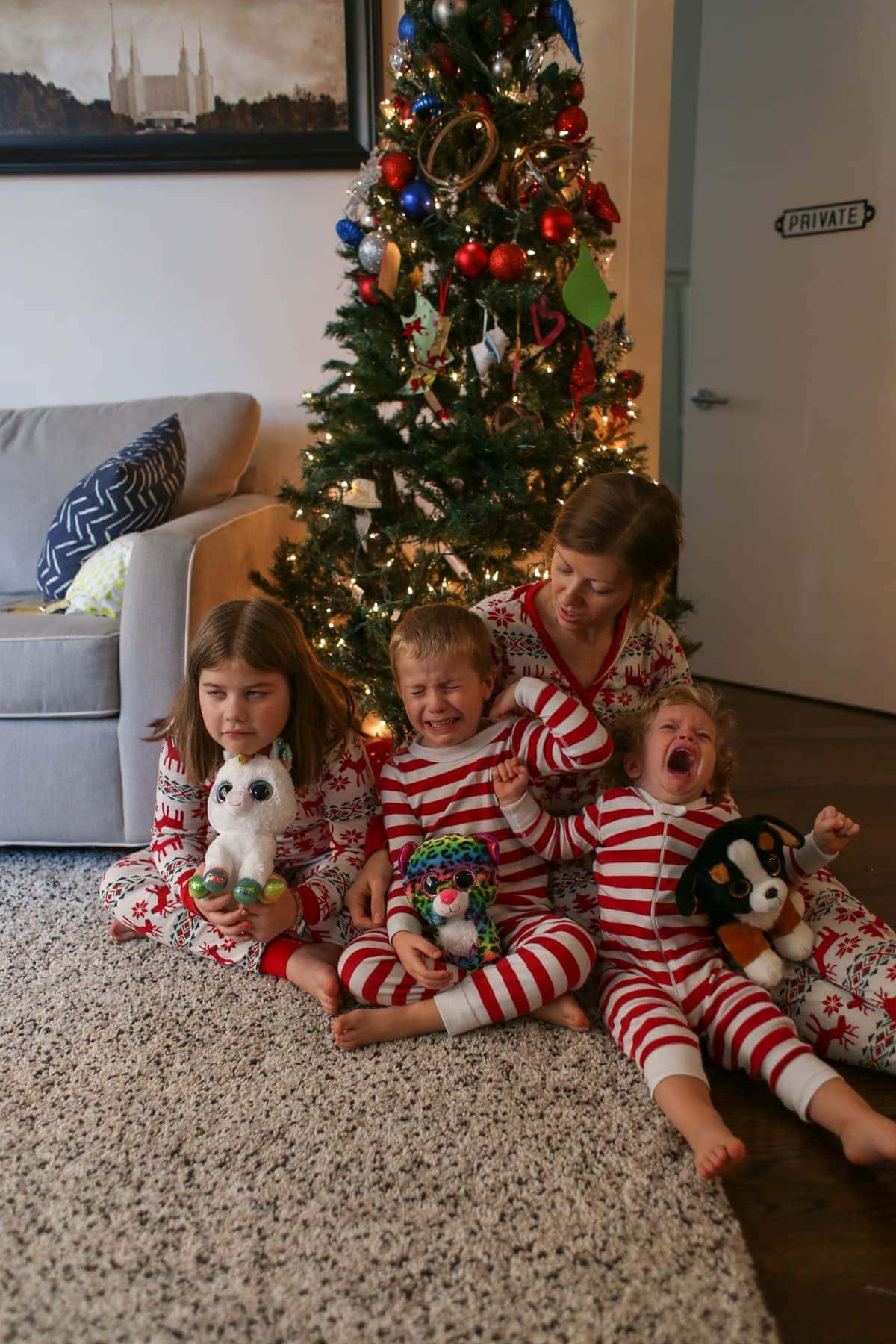 Lauren and the kids in front of the Christmas tree