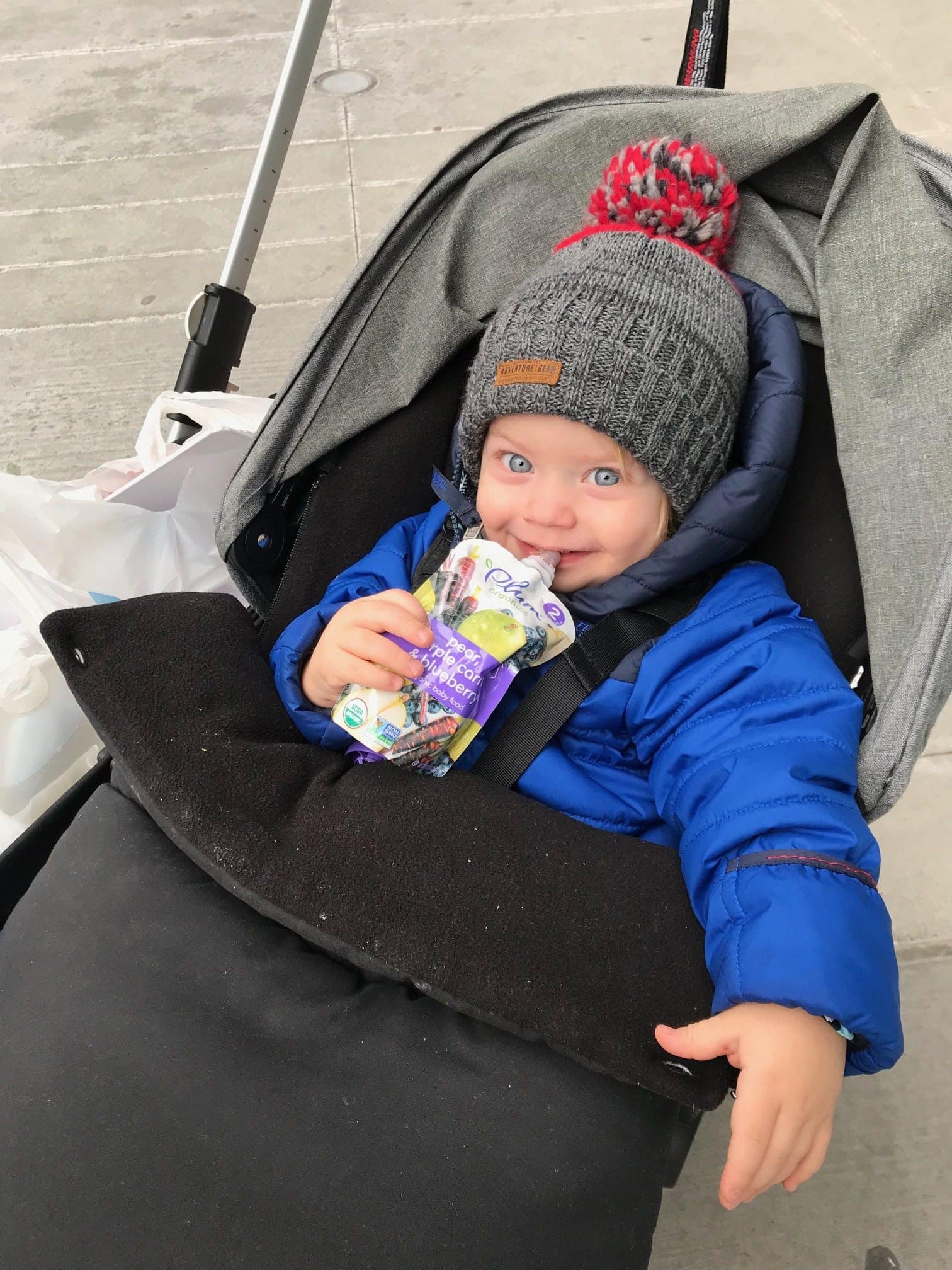 Eddie in the stroller with a snack