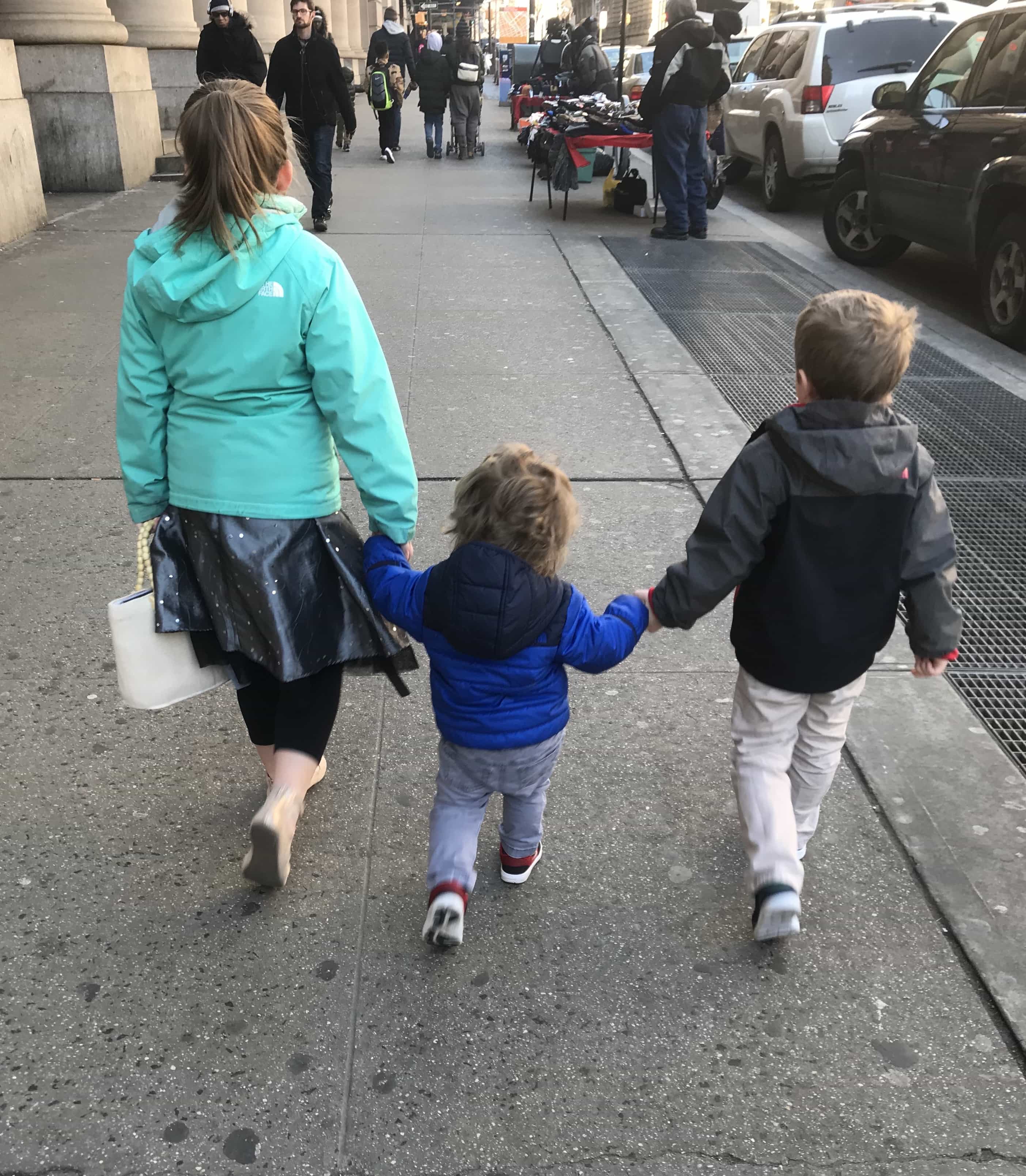 Brooke Blake and Eddie holding hands walking down the sidewalk