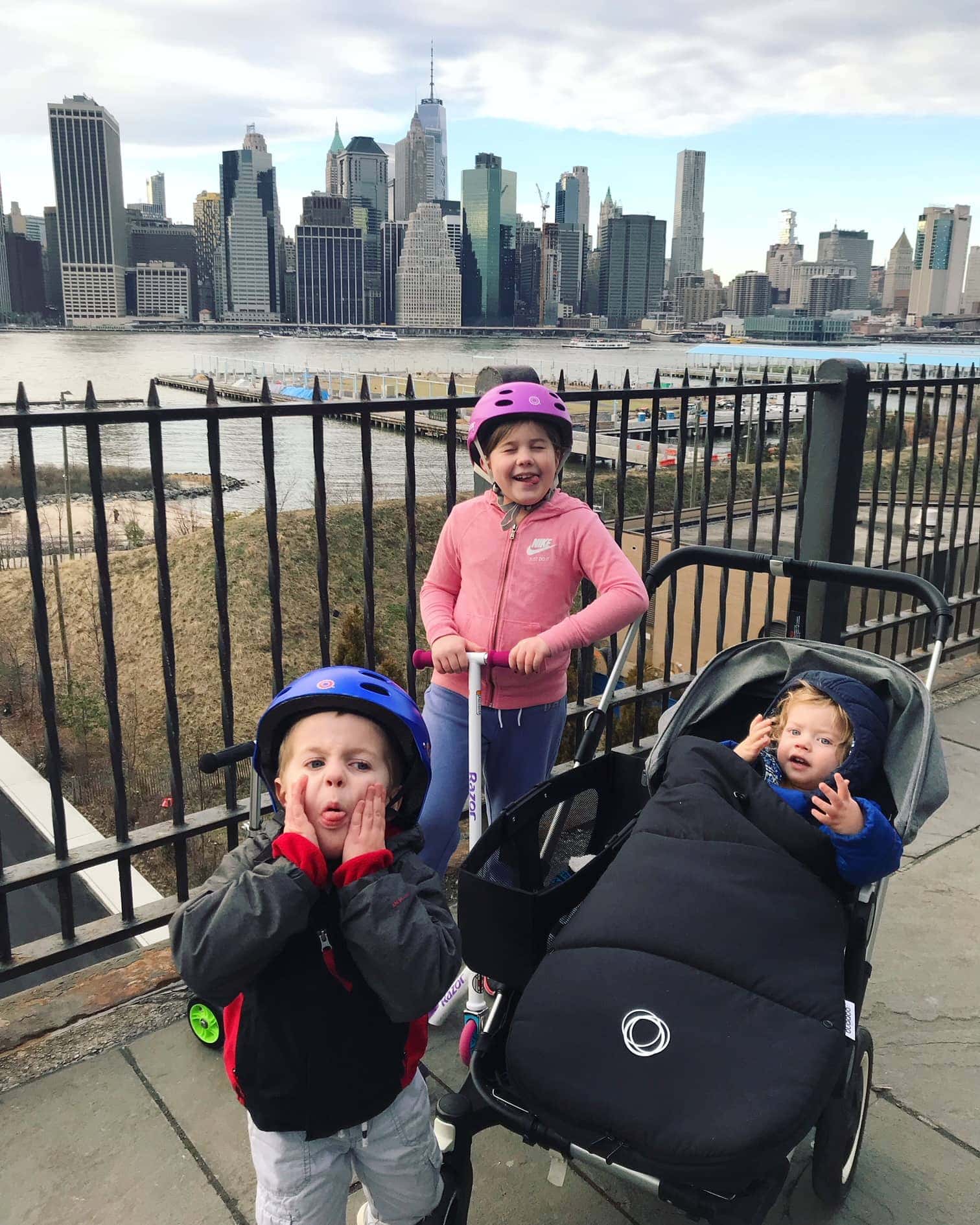 The kids with the city behind them