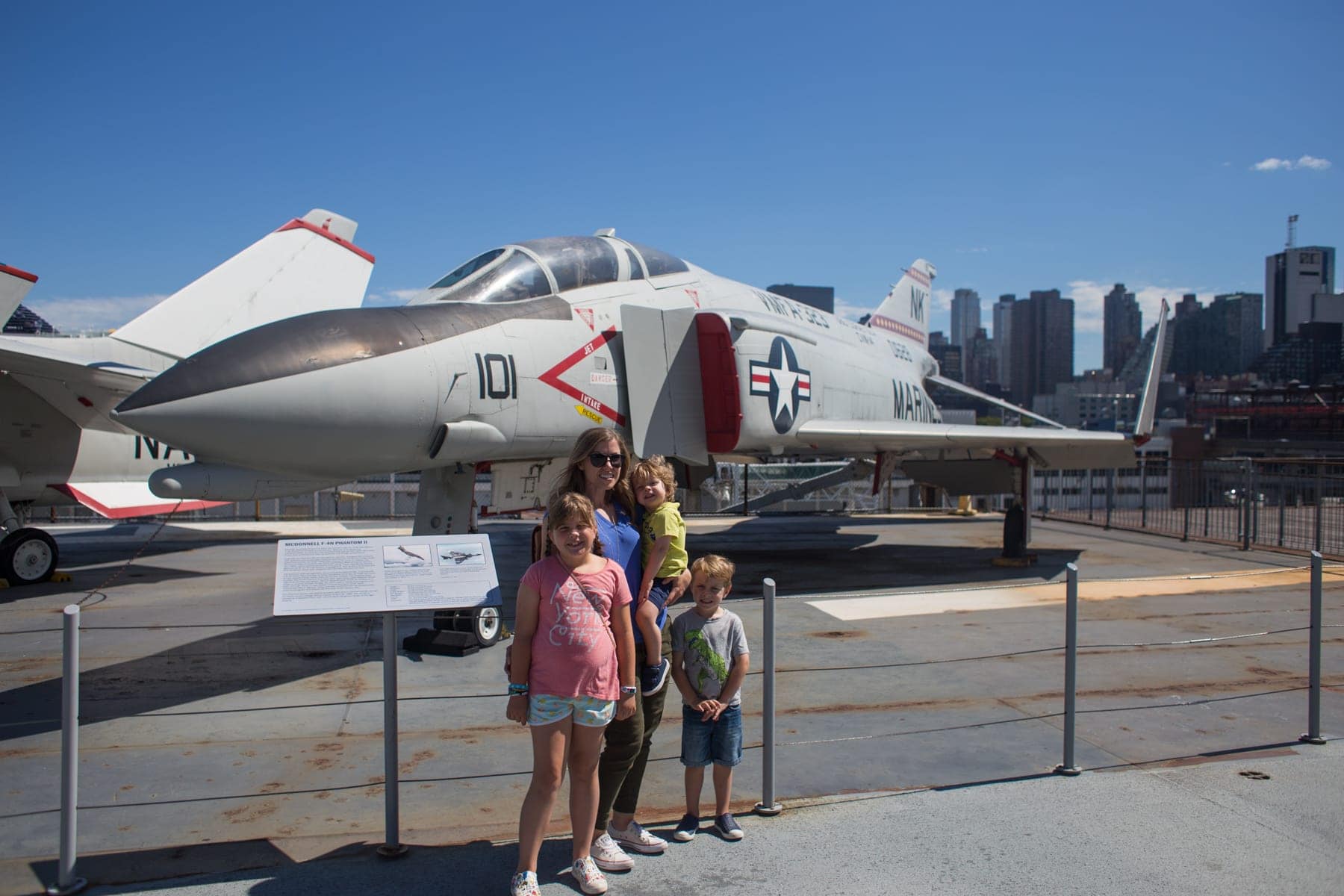 The kids in front of a plane