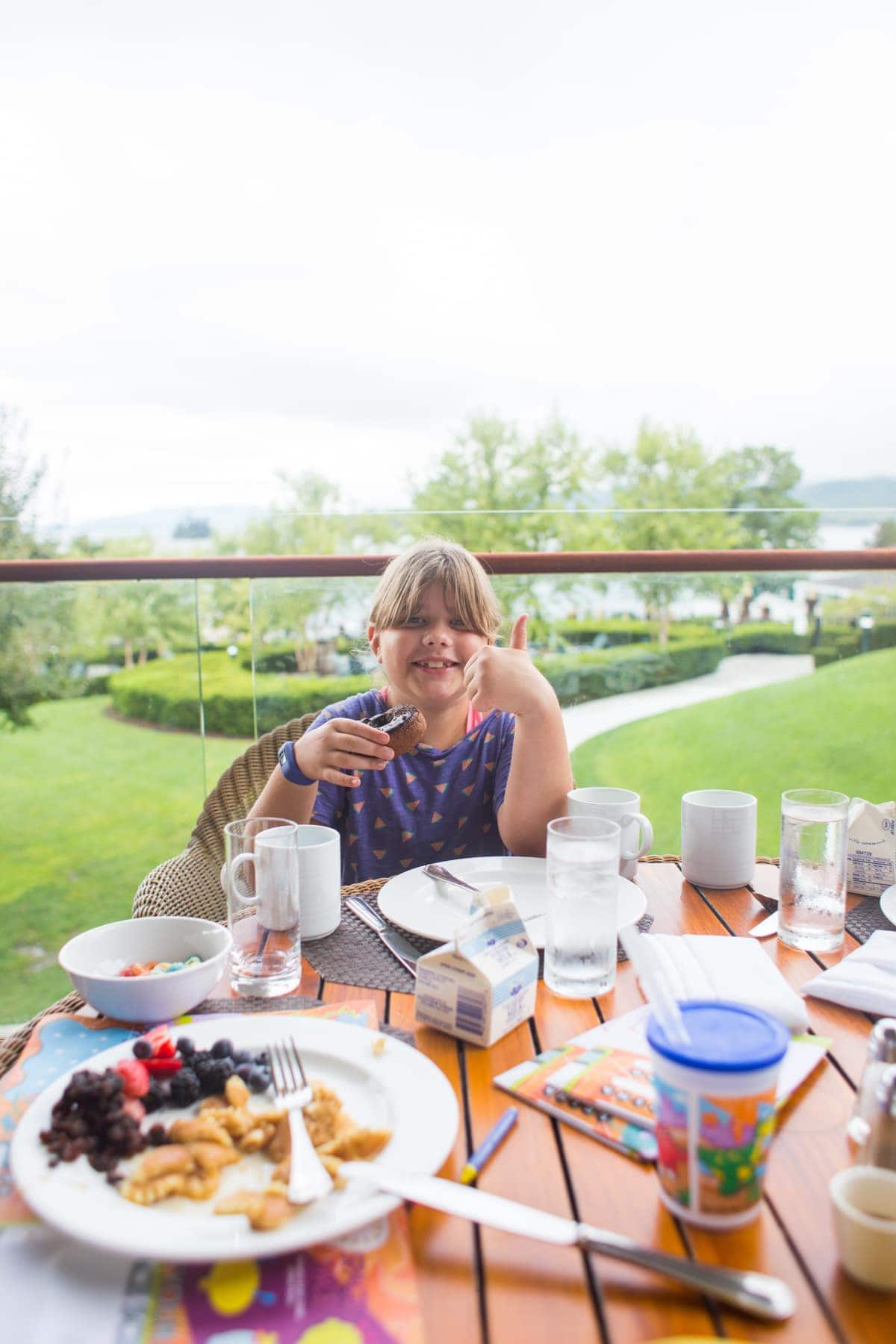 A person sitting at a table with a plate of food