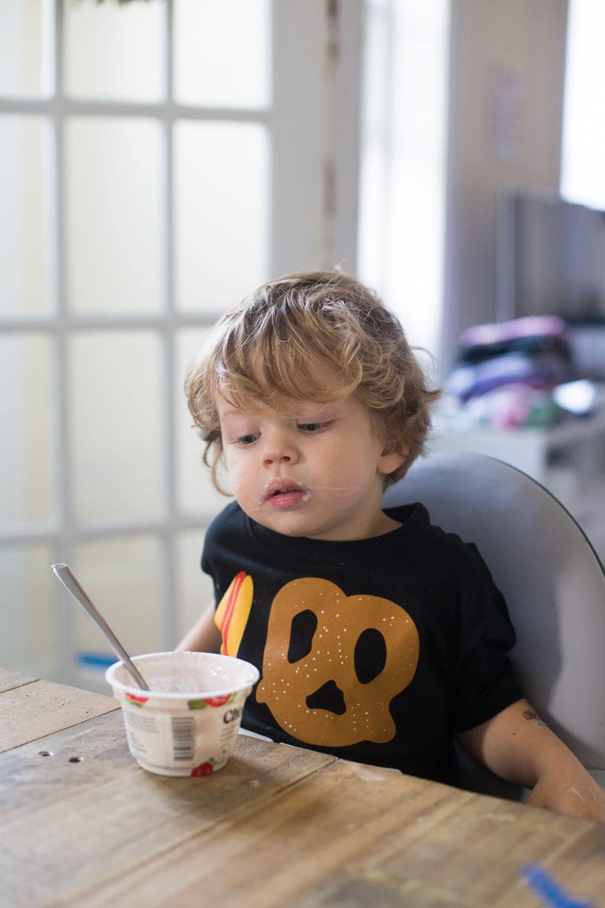 Eddie looking at his yogurt