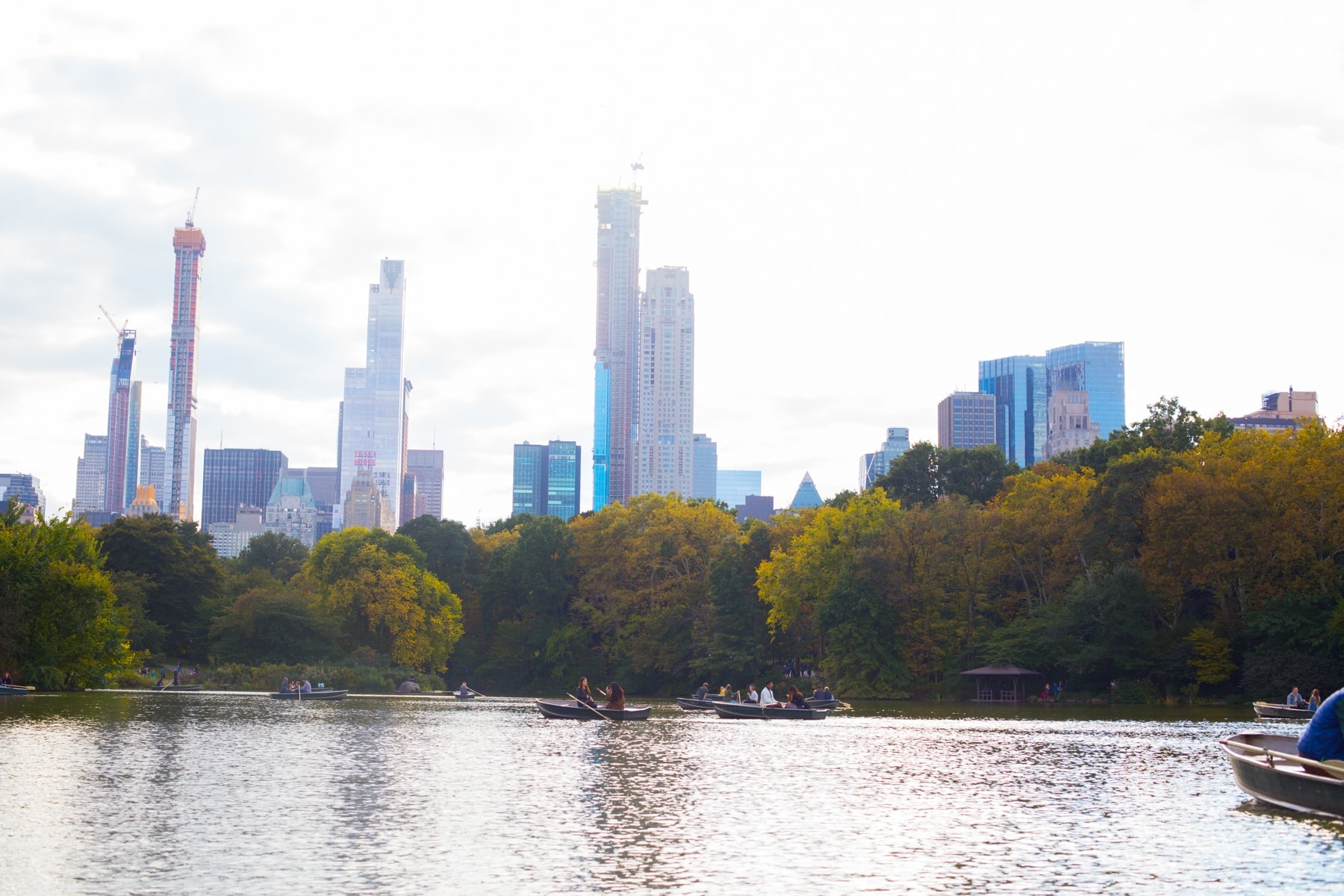 A small boat in a body of water with a city in the background