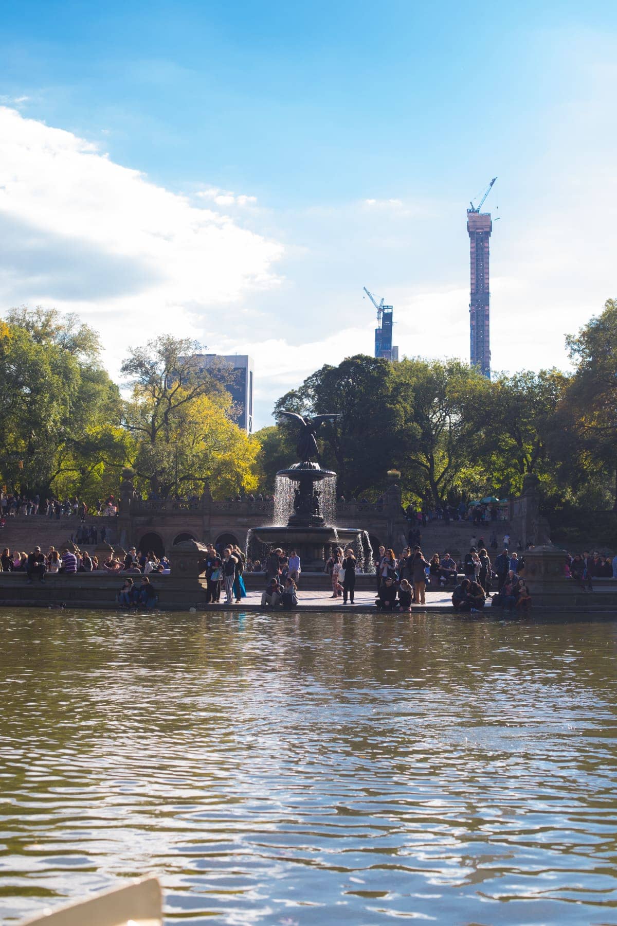 A body of water with a city in the background