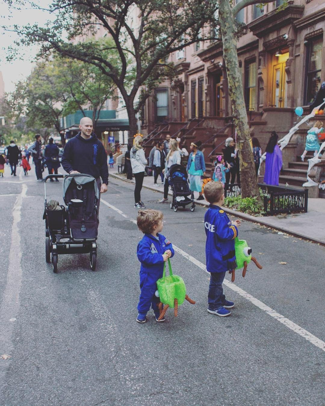 A group of people walking down the street