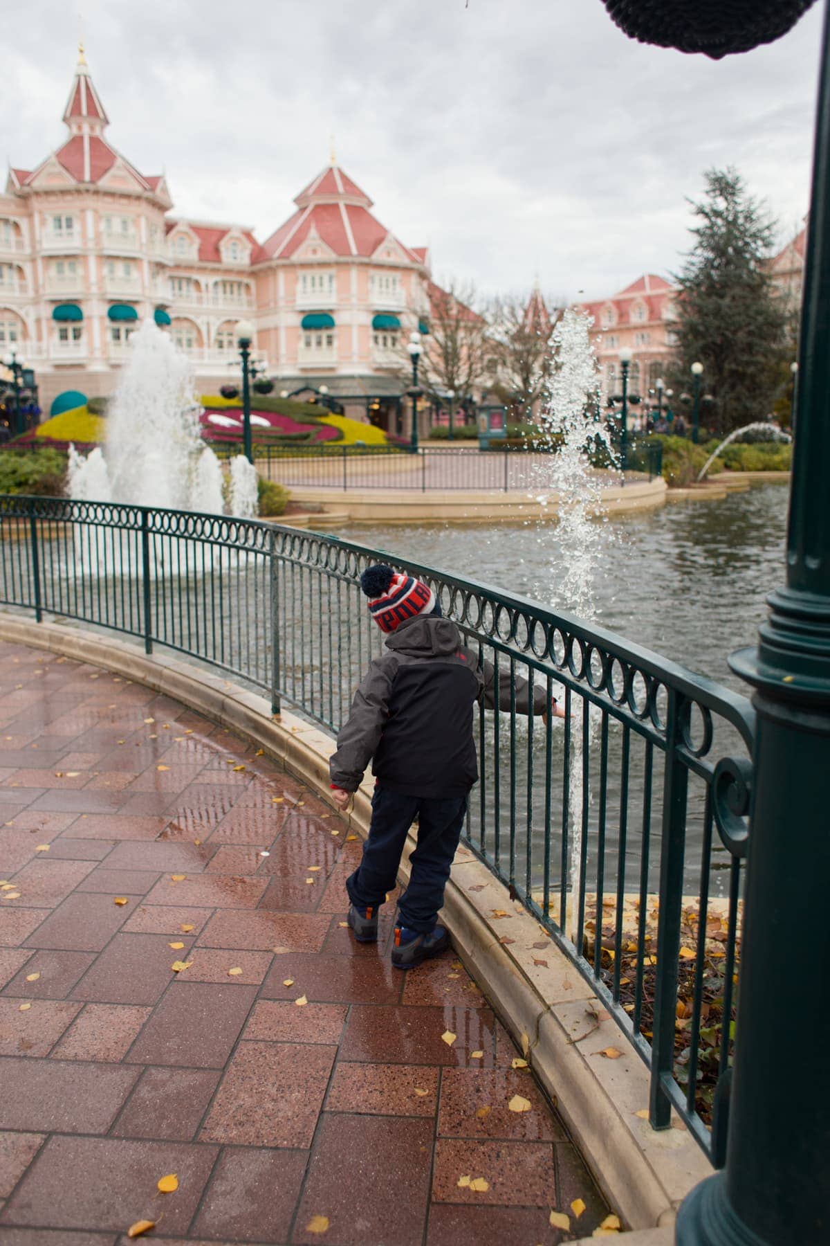A boy walking across a bridge