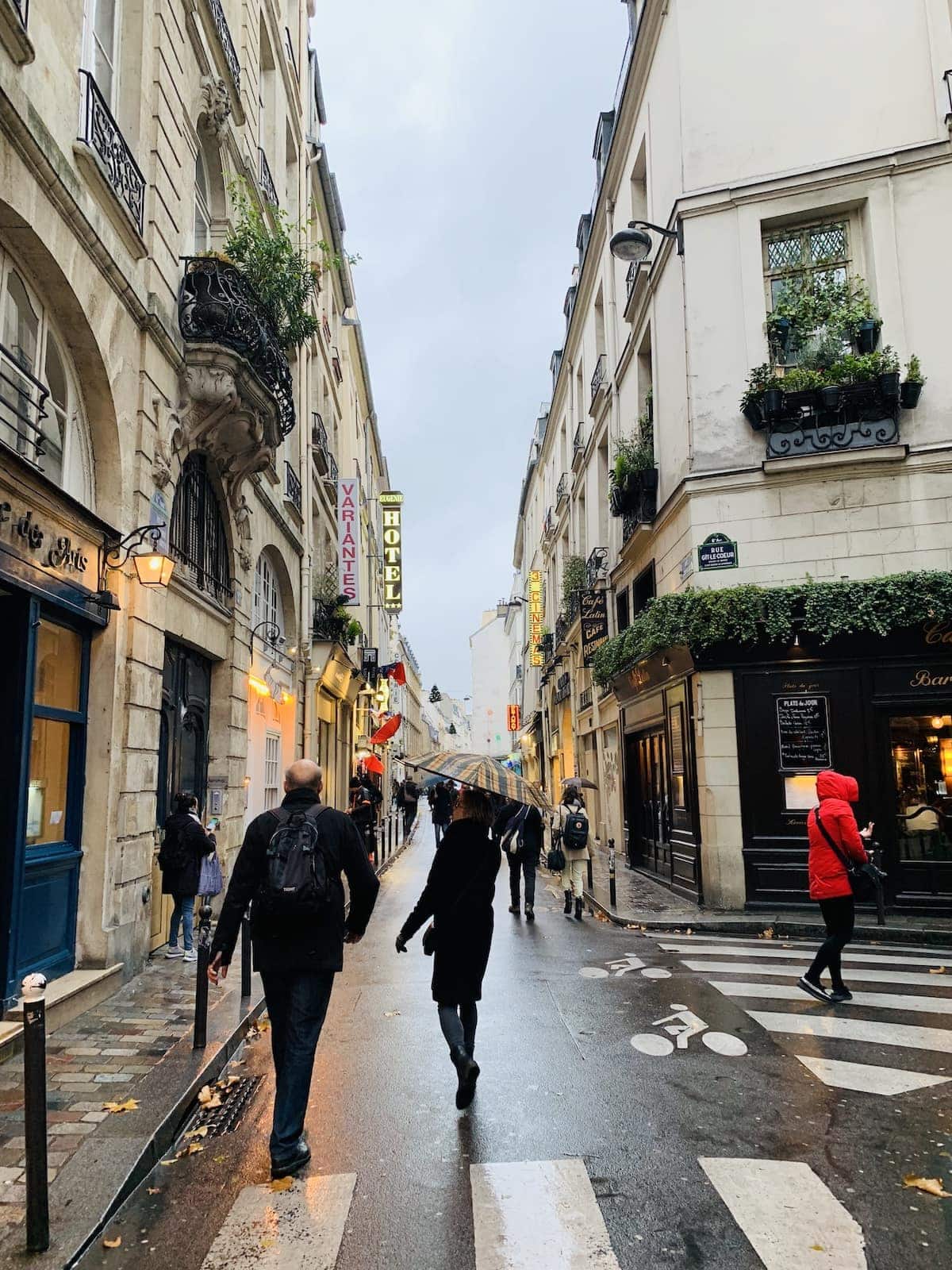 A group of people walking down the street