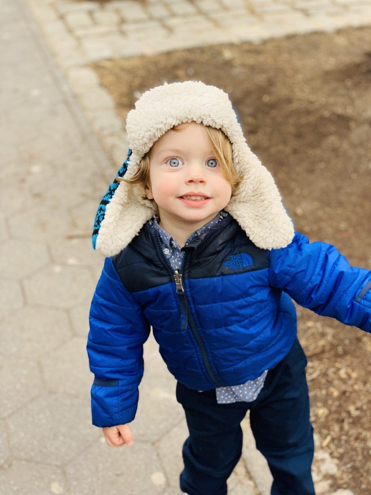 A little boy wearing a blue hat