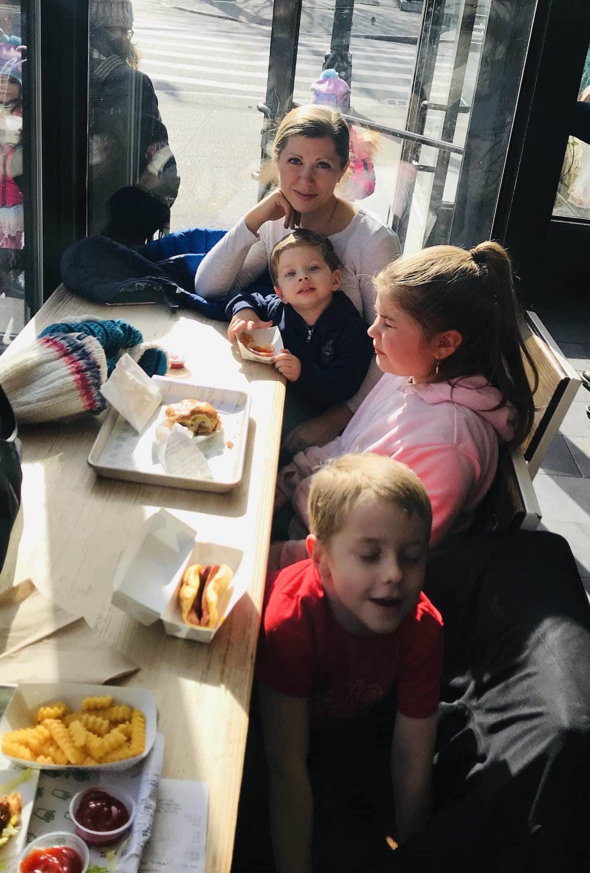 A group of people sitting at a table eating food