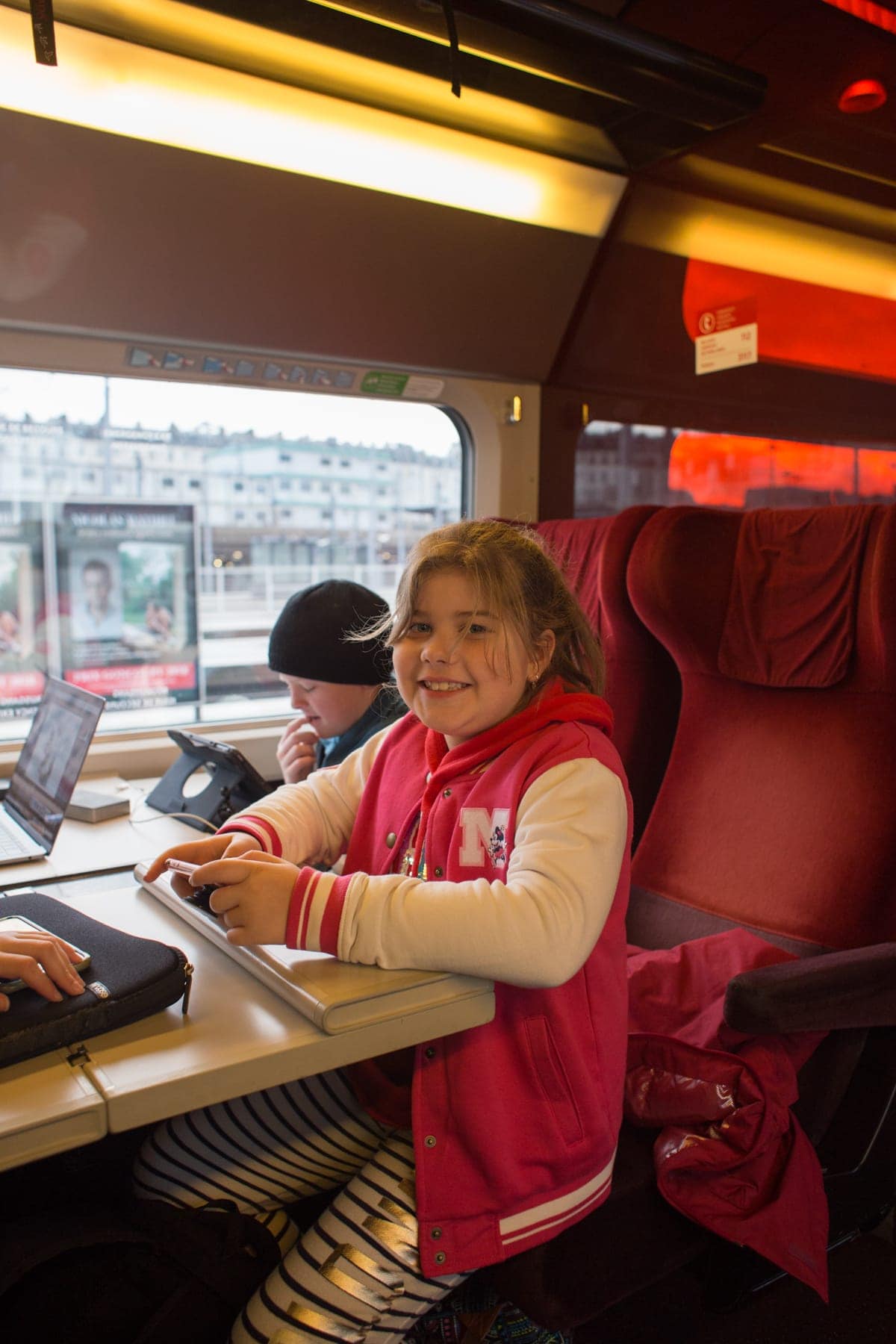 A little girl sitting at a table