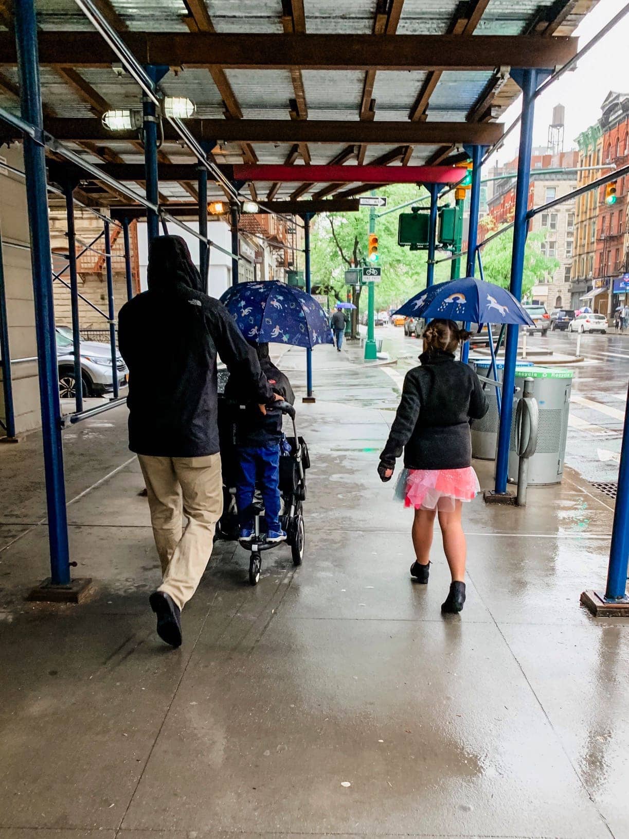 Gordon and the kids walking to church in the rain