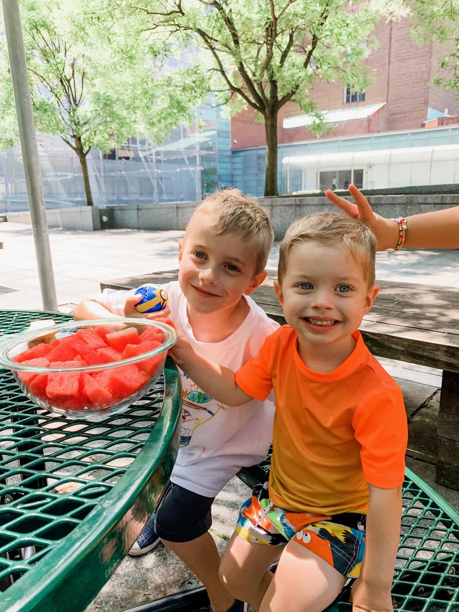 Blake and Eddie eating watermelon at the table