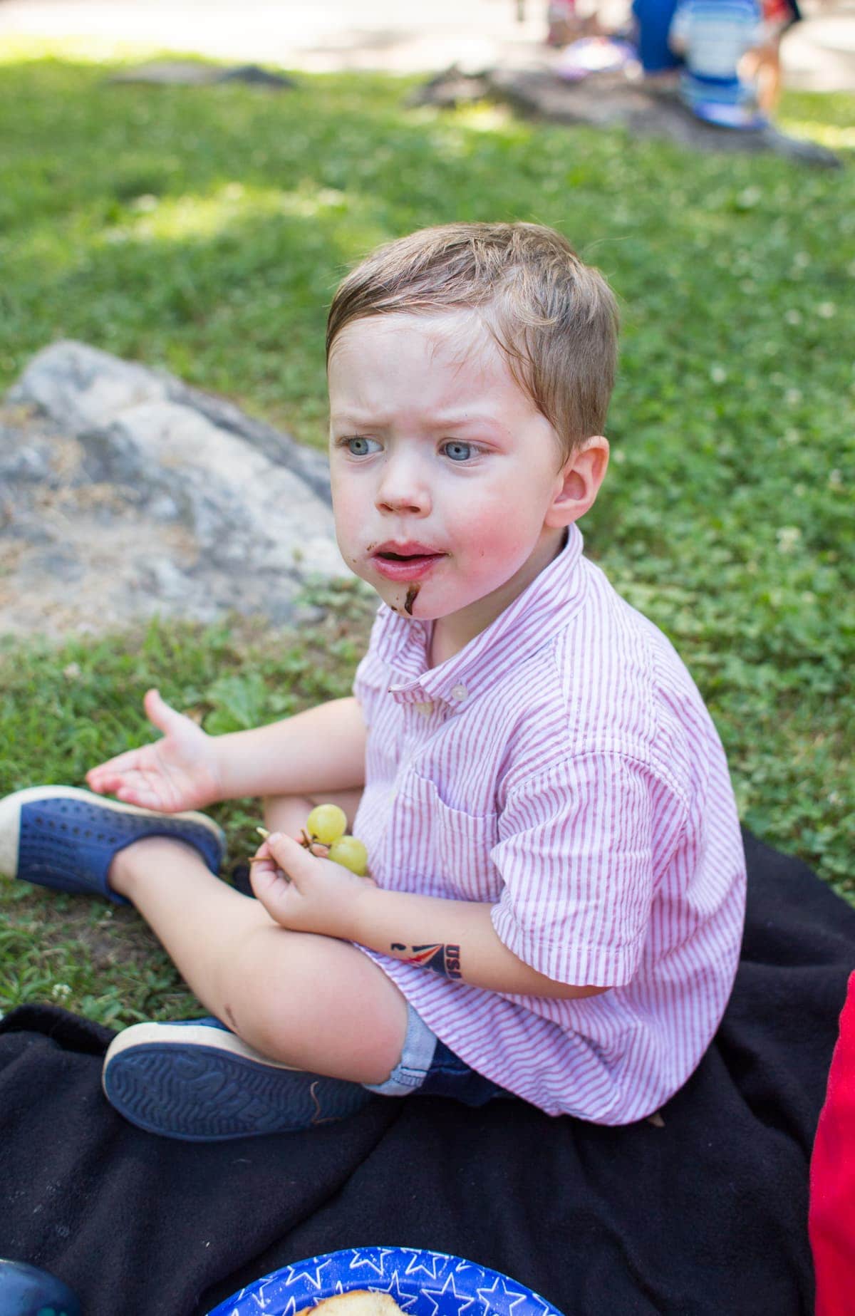 Eddie eating grapes in the grass