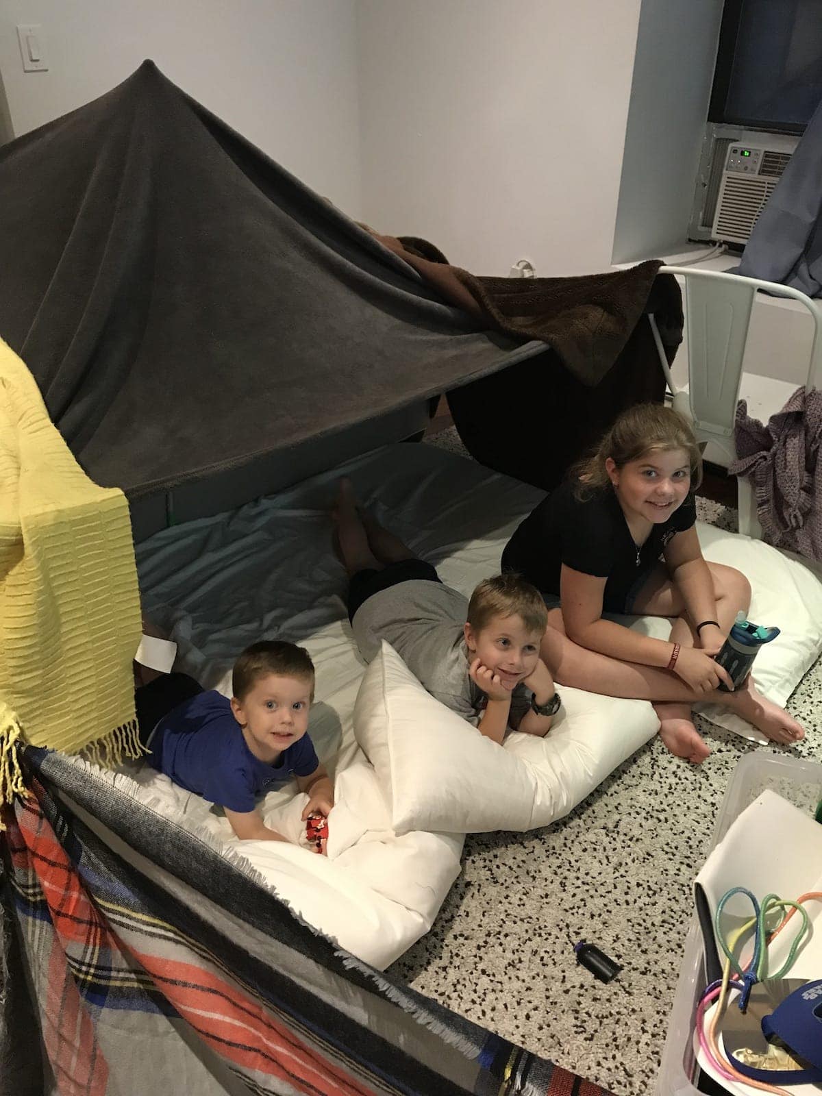 The kids under their blanket fort