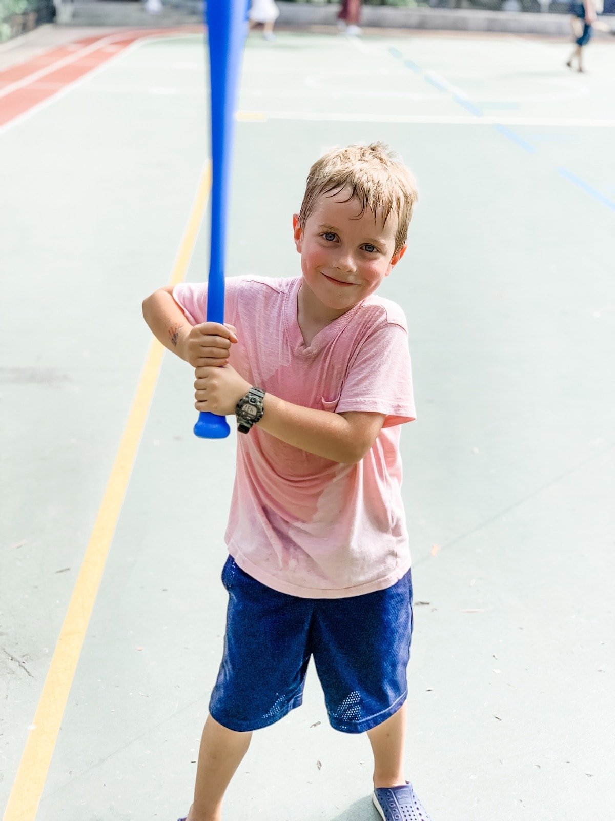 A little boy that is holding a bat