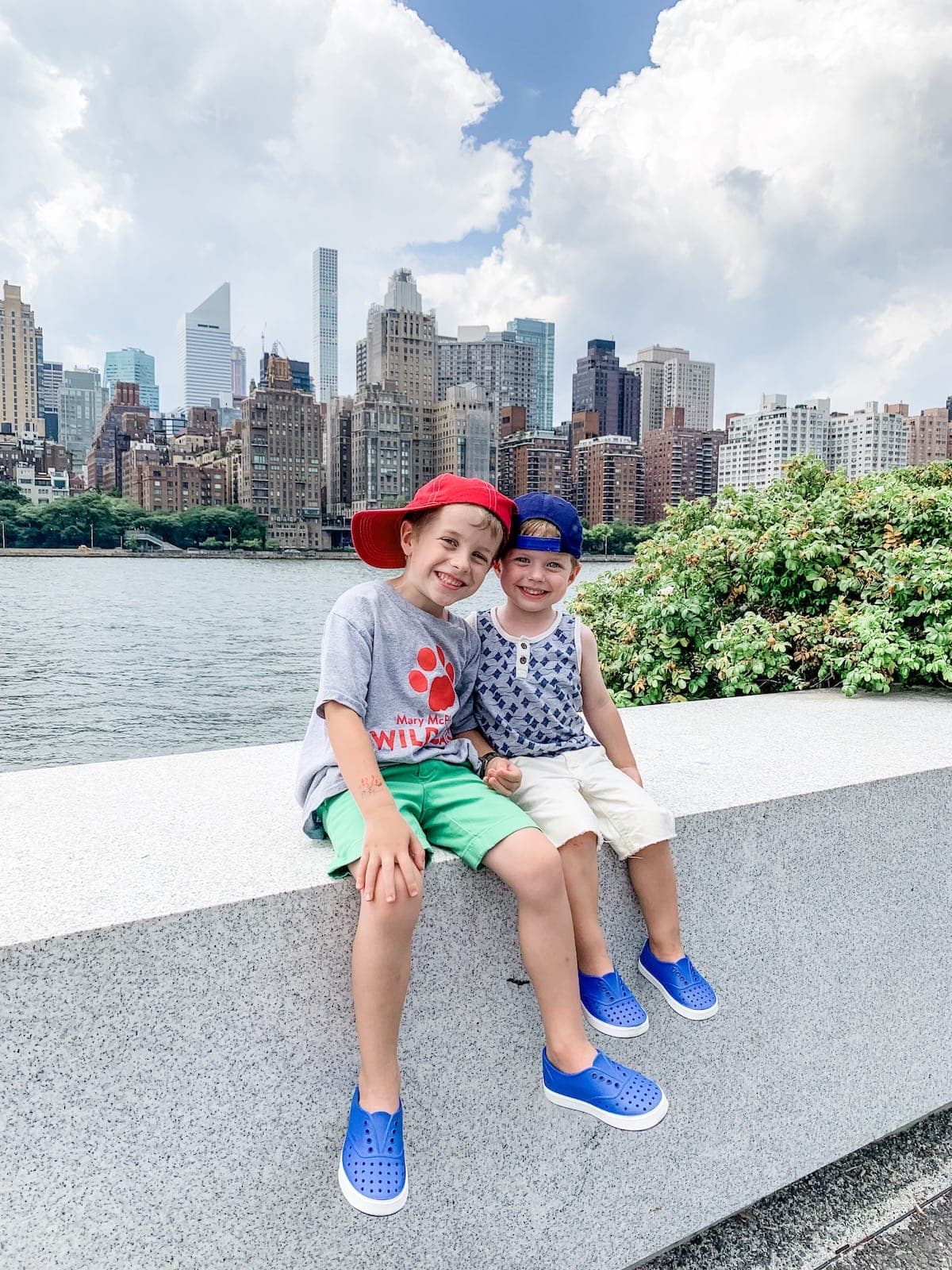 Blake and Eddie sitting with the city skyline behind them