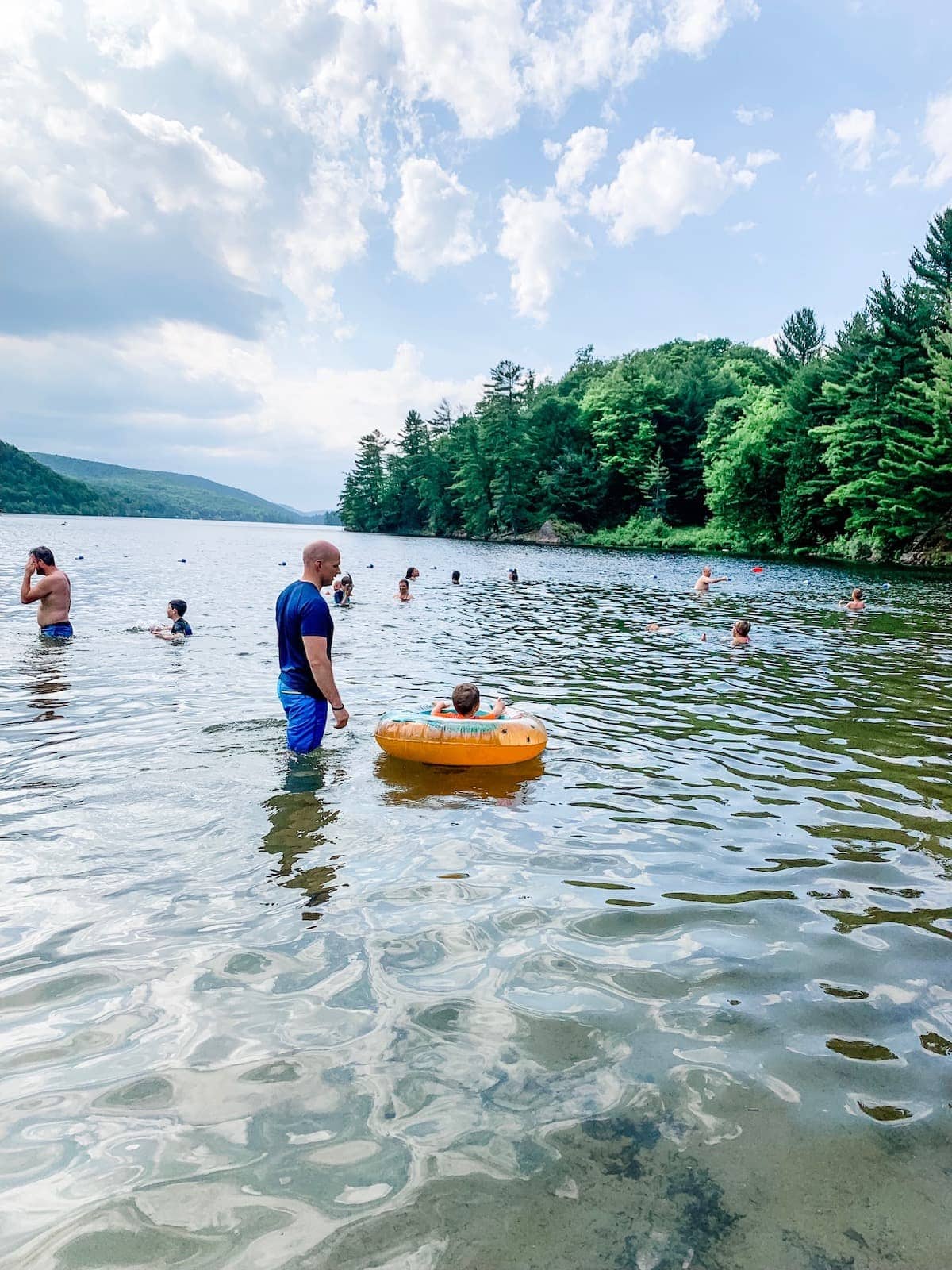 A group of people swimming in a body of water