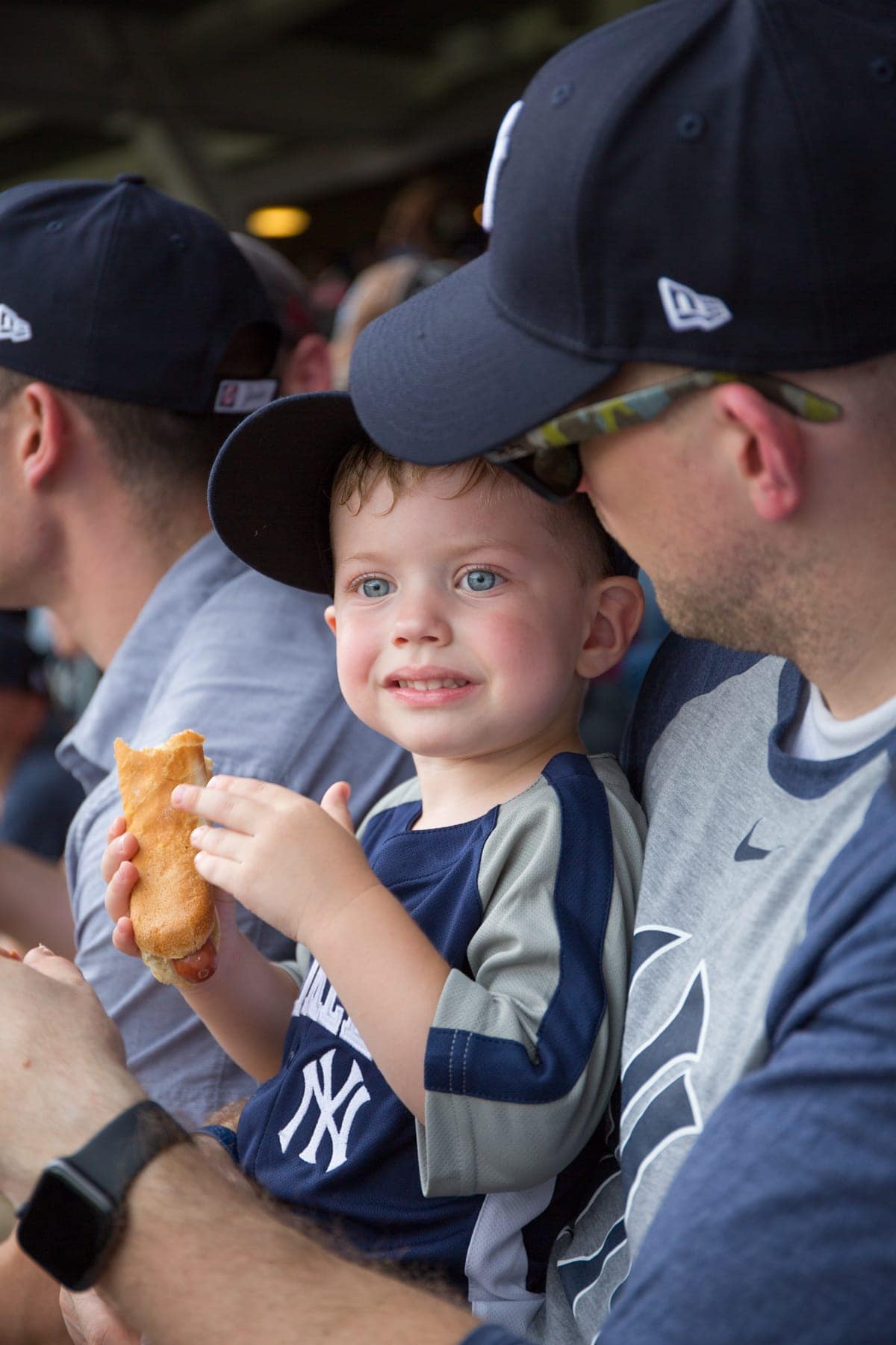 A young boy eating a hot dog