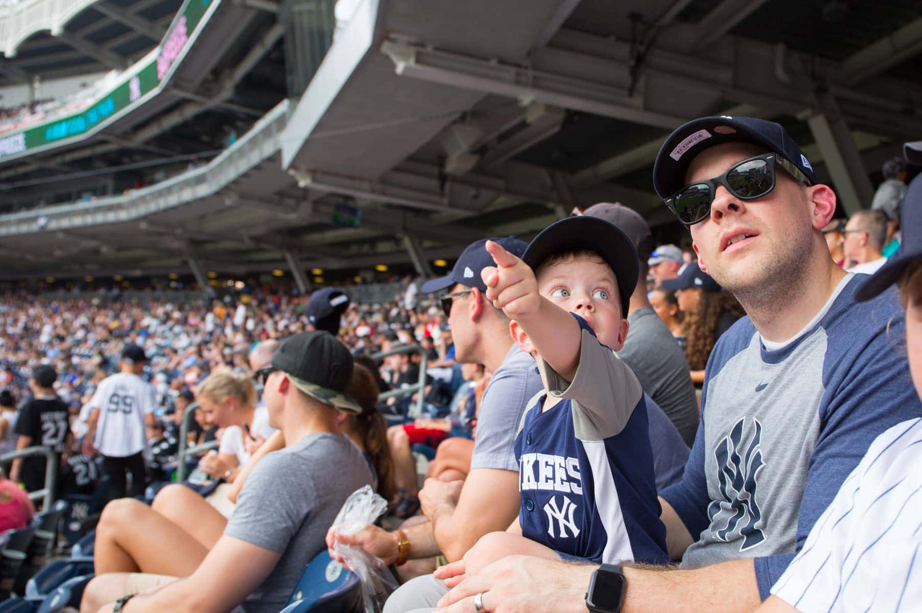 Eddie pointing to something at a baseball game