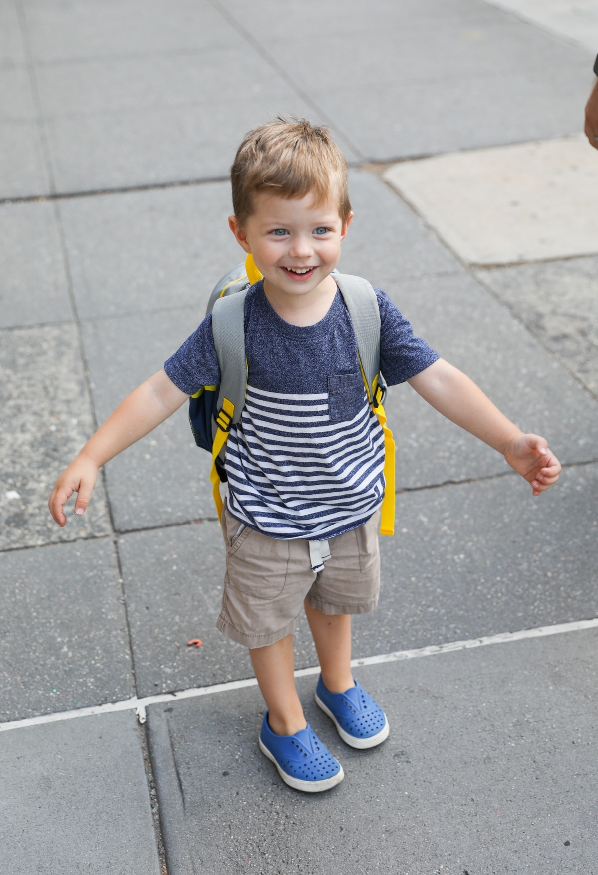 Eddie standing on a sidewalk