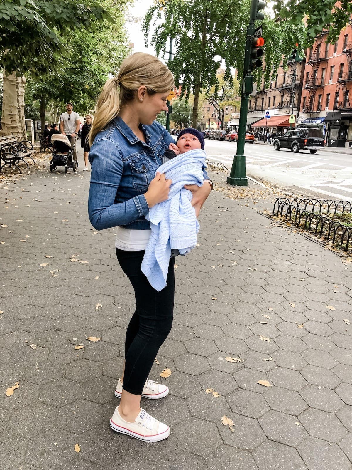 Lauren holding Porter on the sidewalk