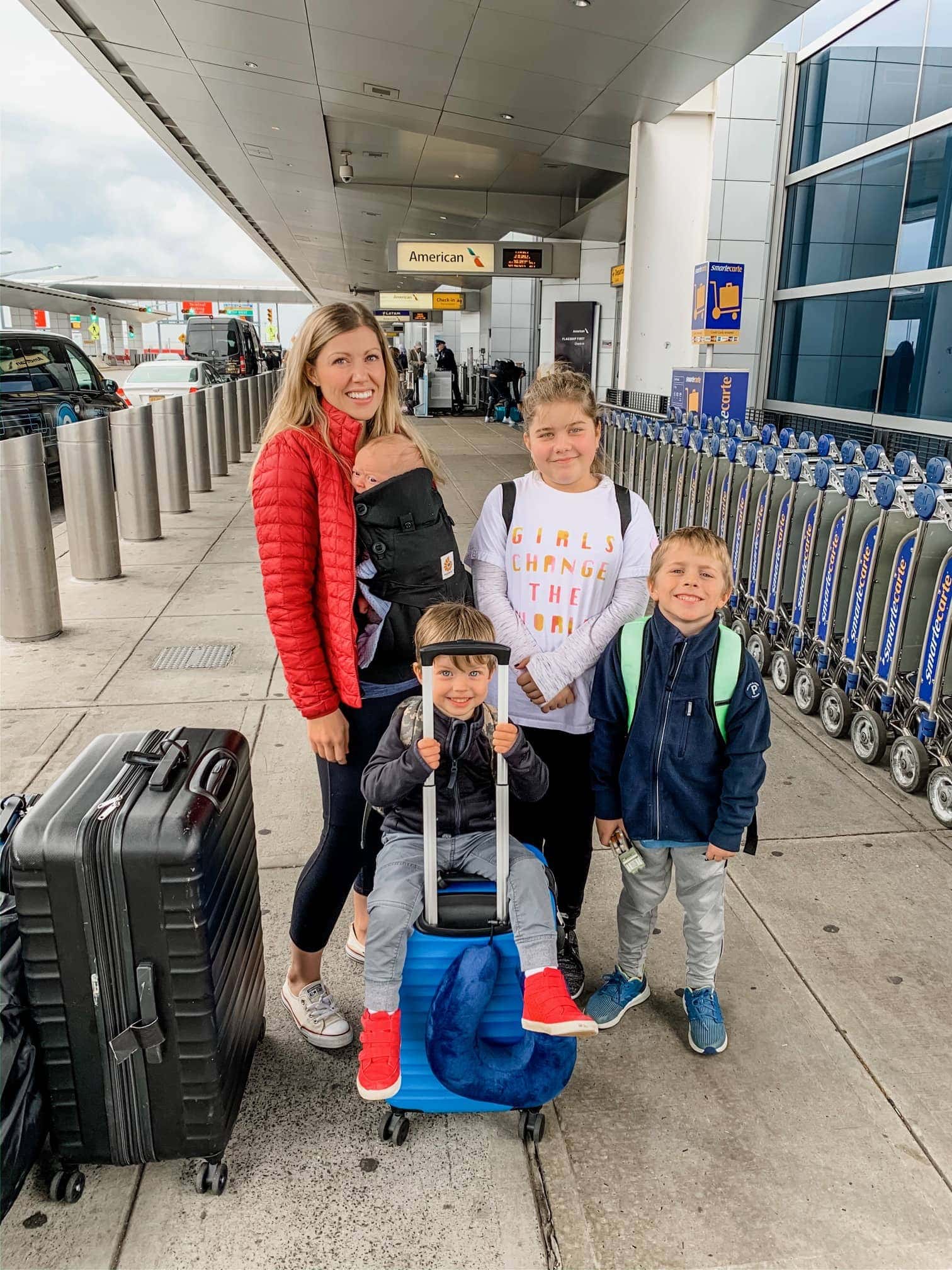 Lauren and the kids standing around bags of luggage