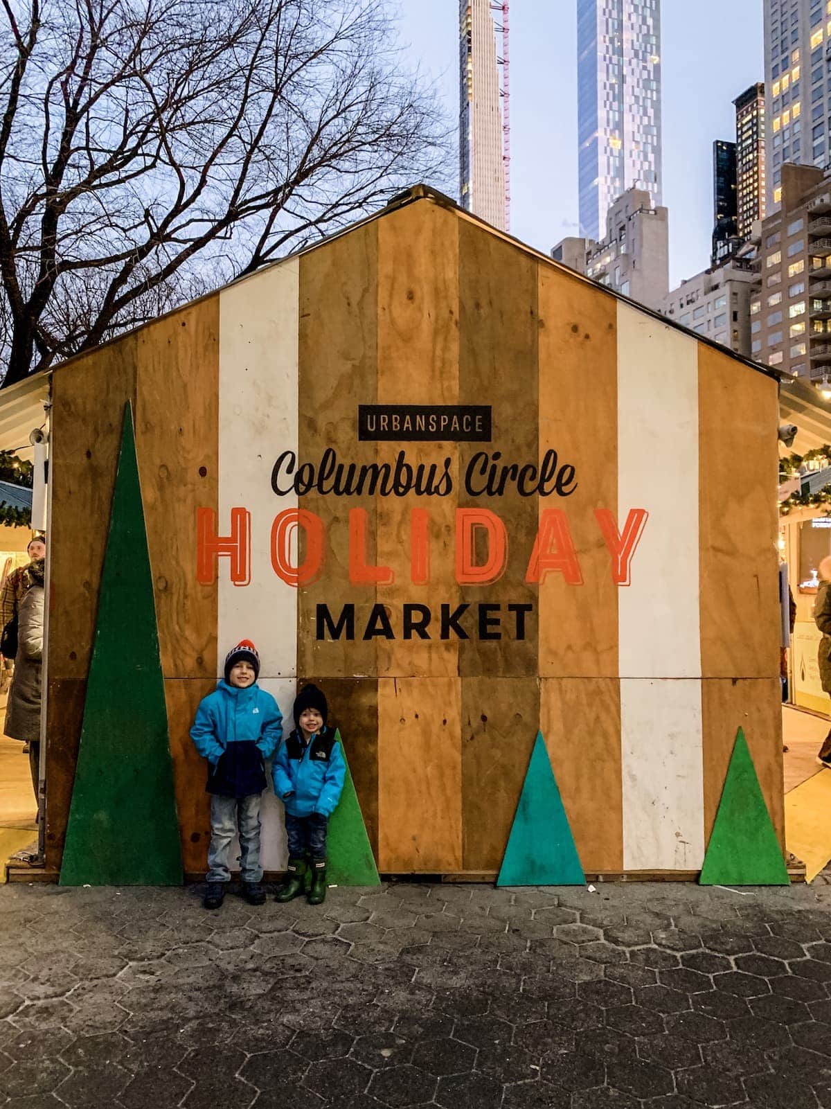 Blake and Eddie standing in front of a Holiday Market building