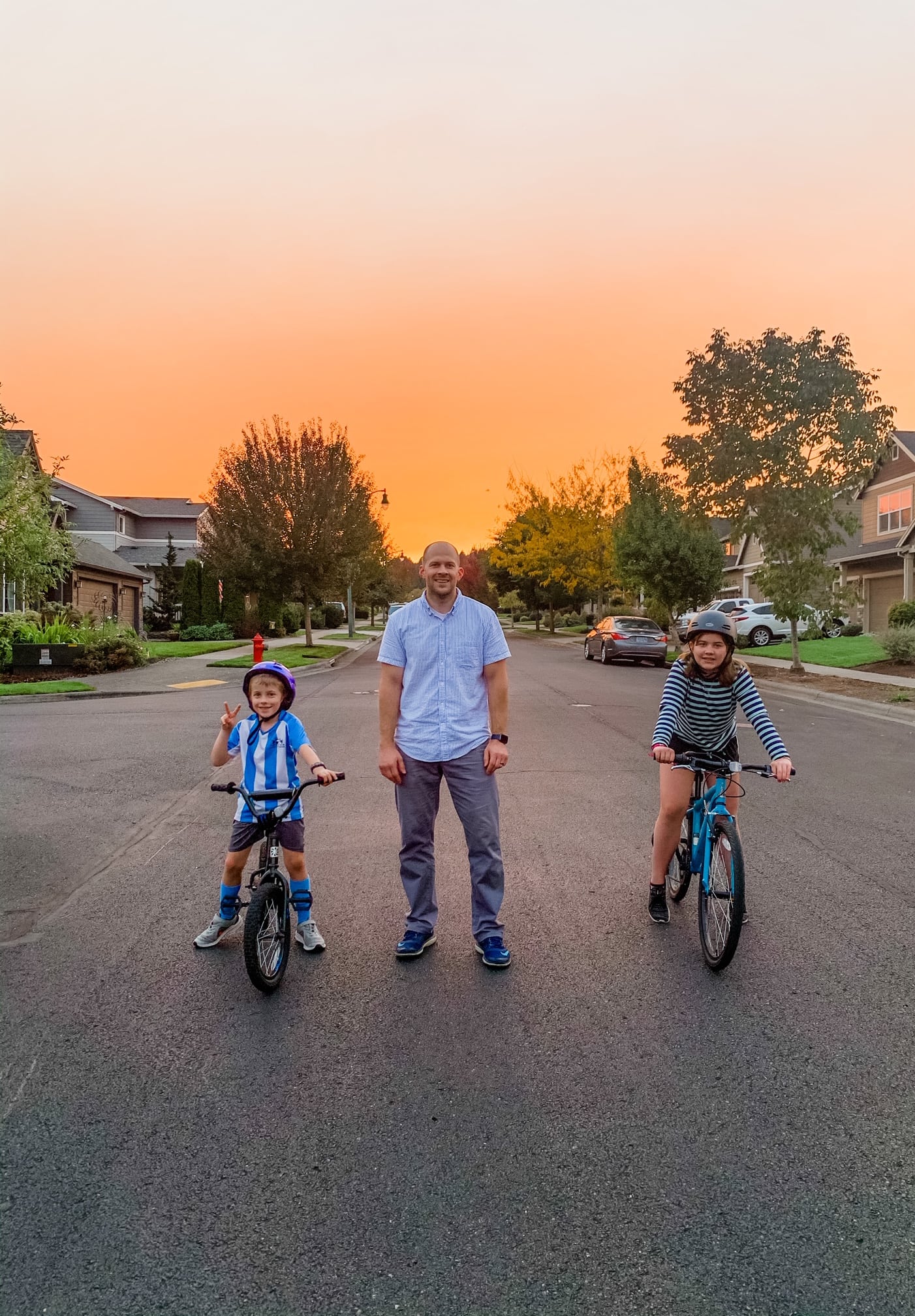 family posing with the sunset