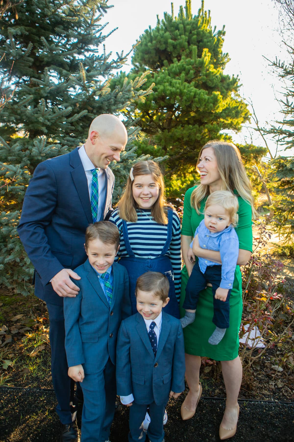 family smiling in forest
