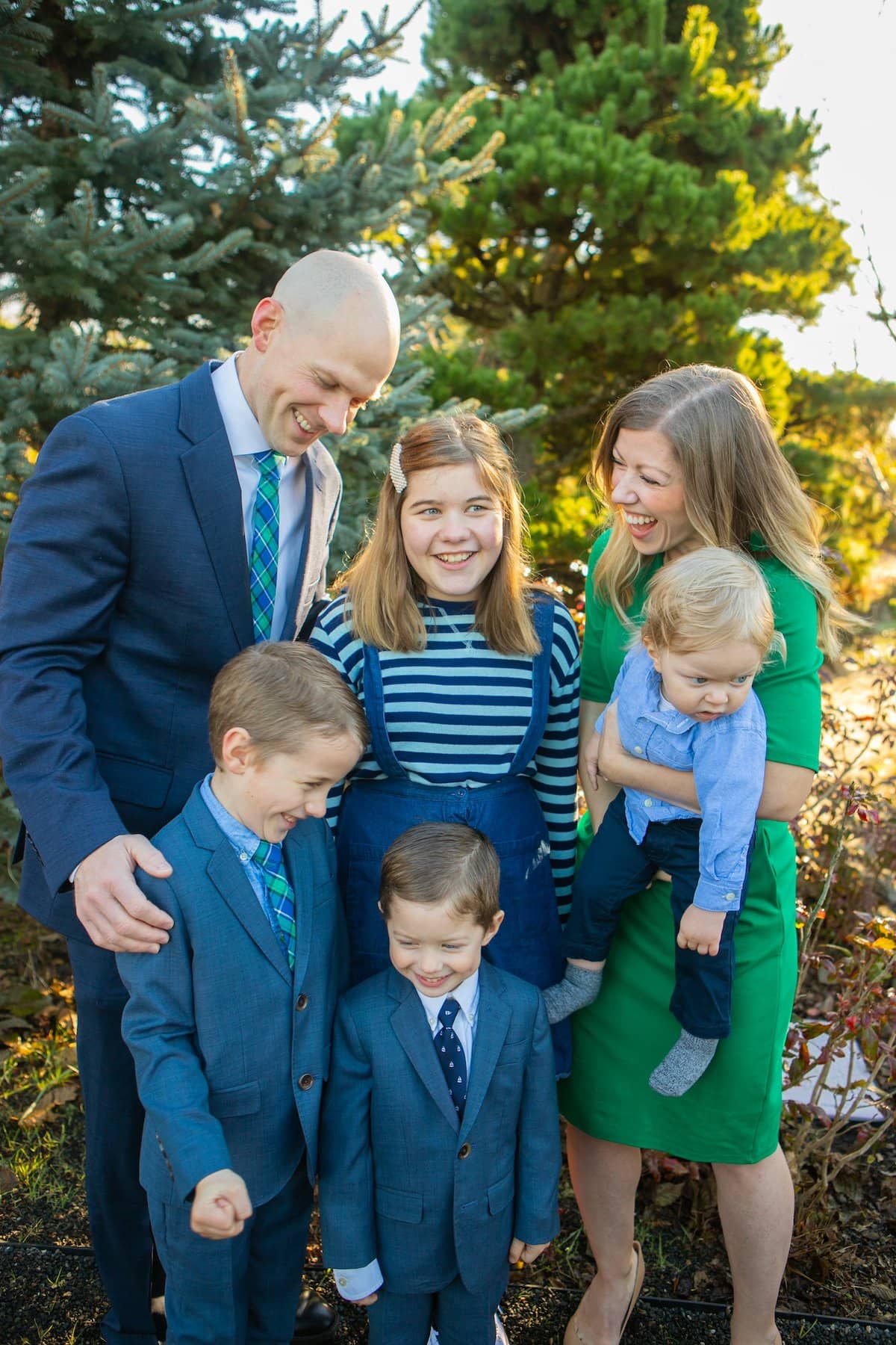family smiling in forest