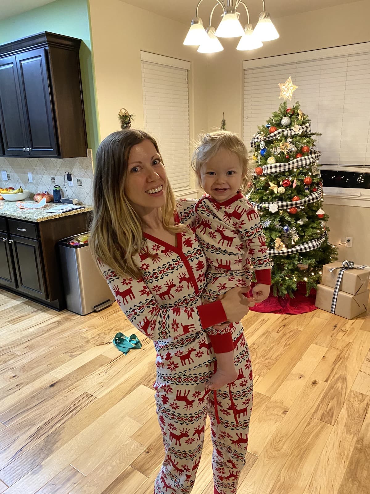mom holding baby in christmas pajams