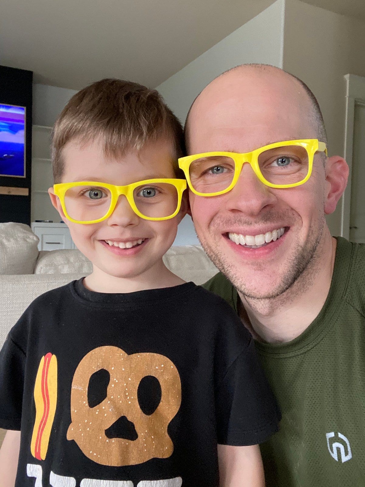 father and son with matching glasses