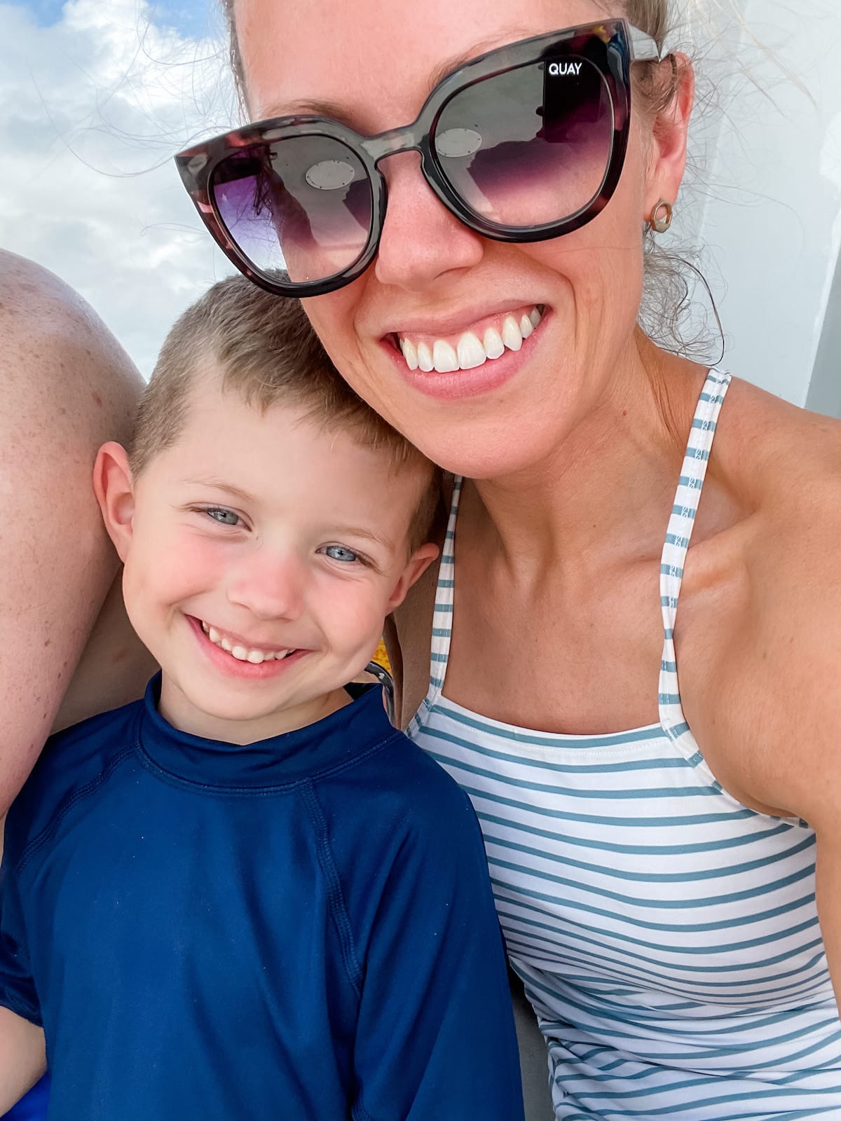 mom with sunglasses smiling with boy