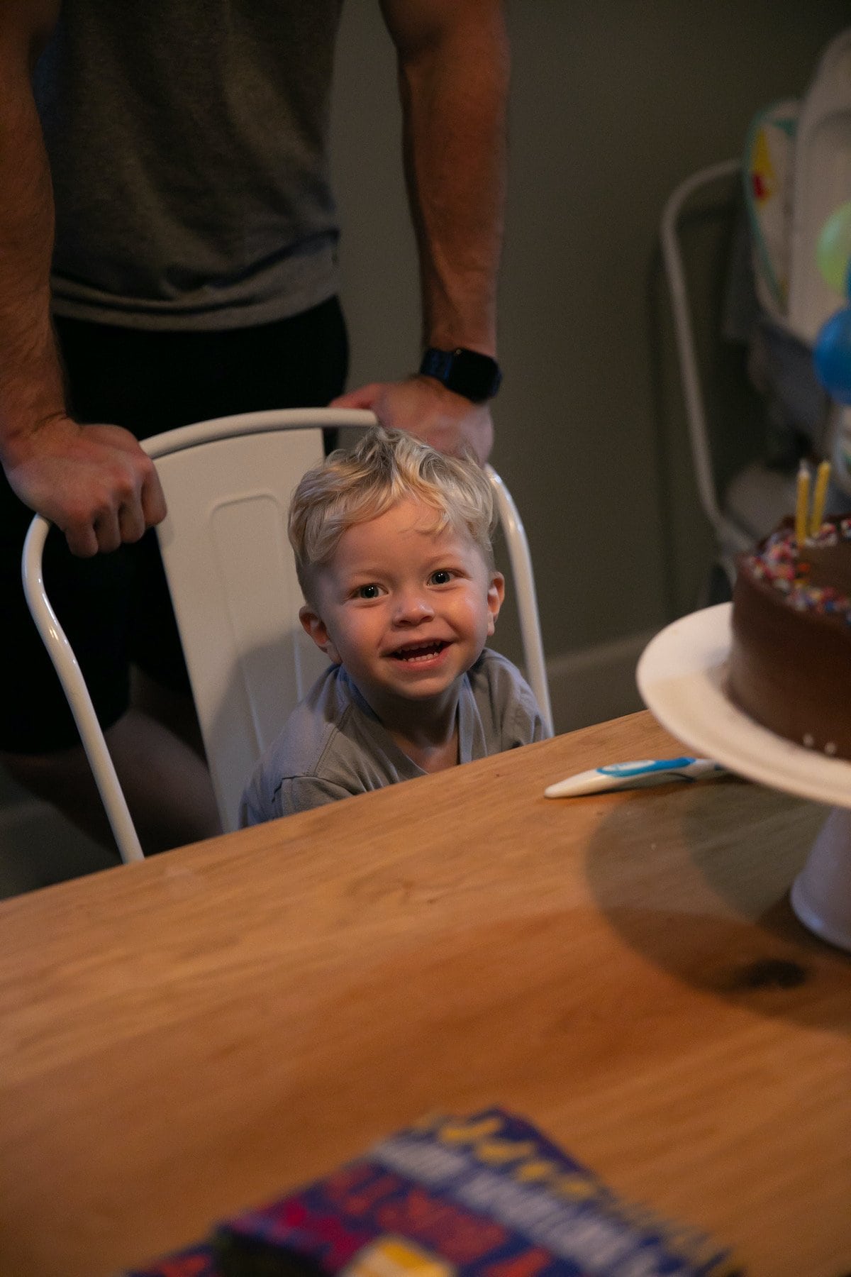 baby smiling at camera sitting on chair