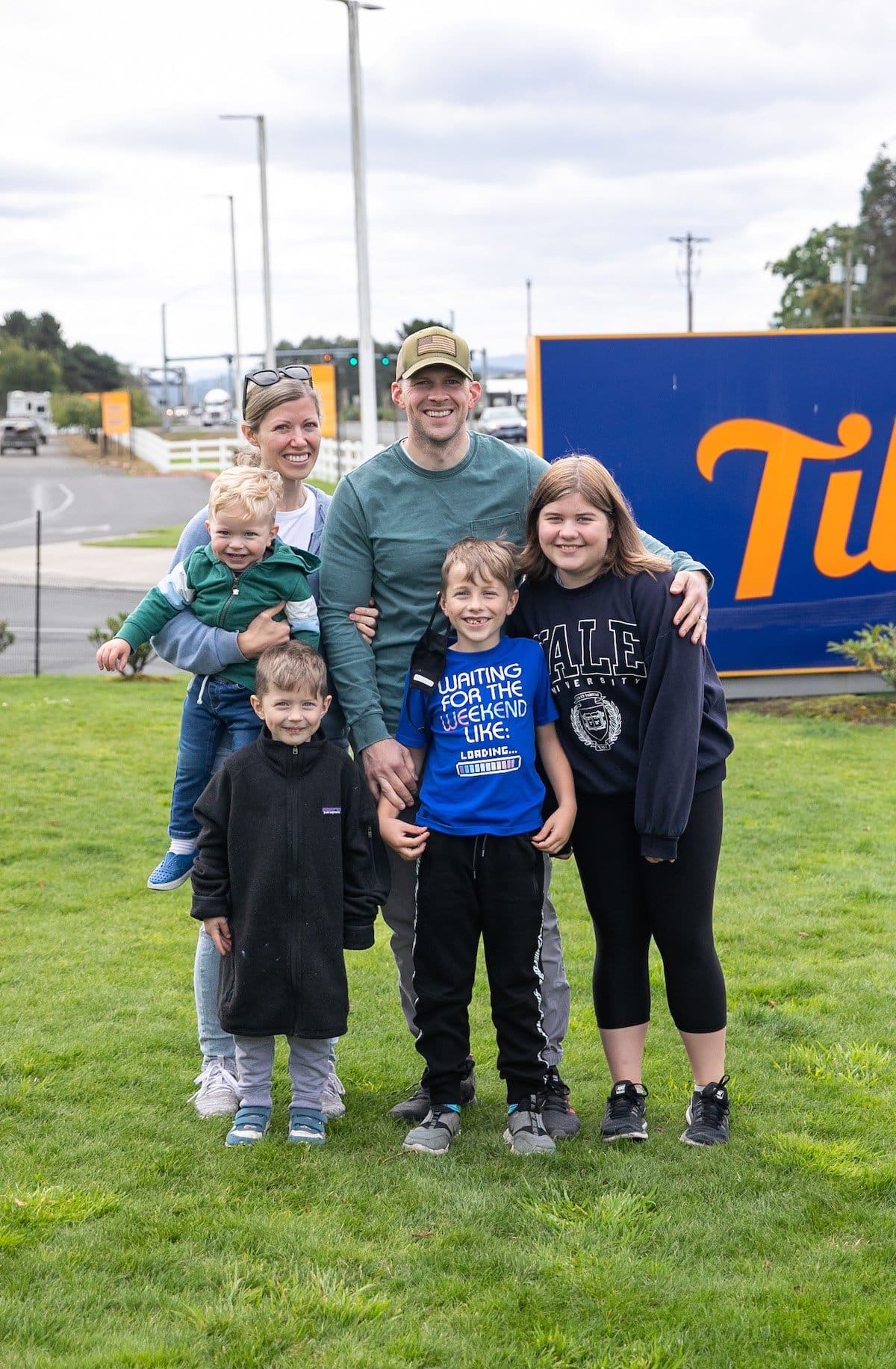 family photo in front of sign