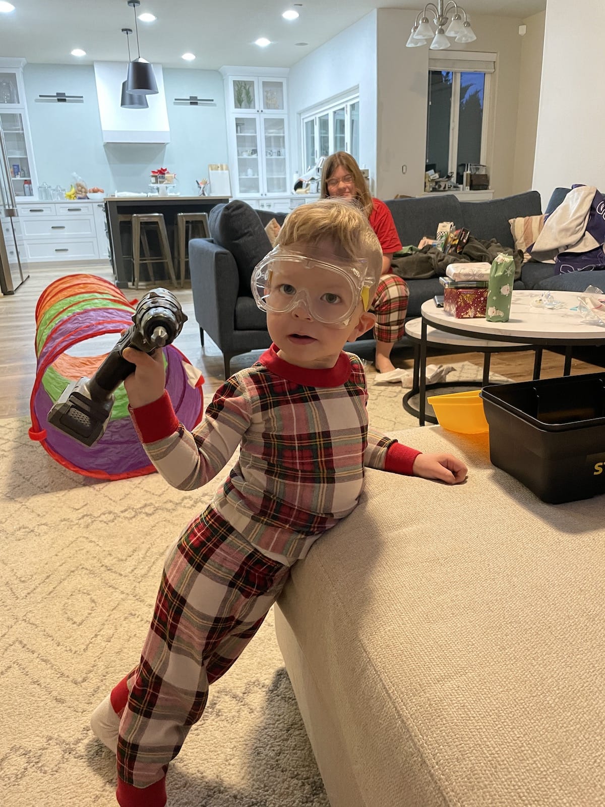 little boy with googles and drill