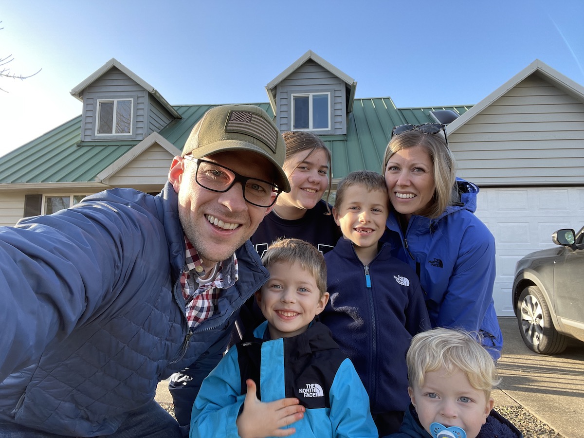 family in front of beach house
