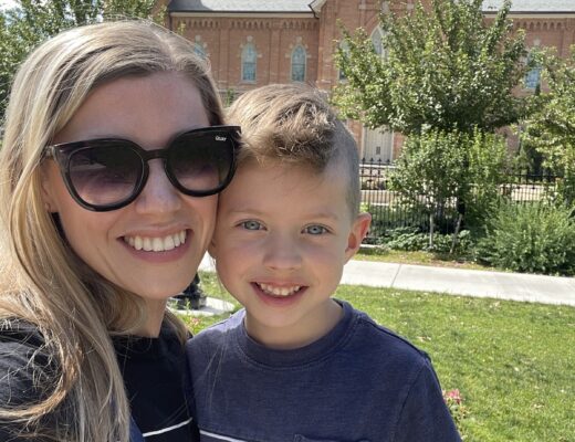 mom and son smiling in front of provo temple