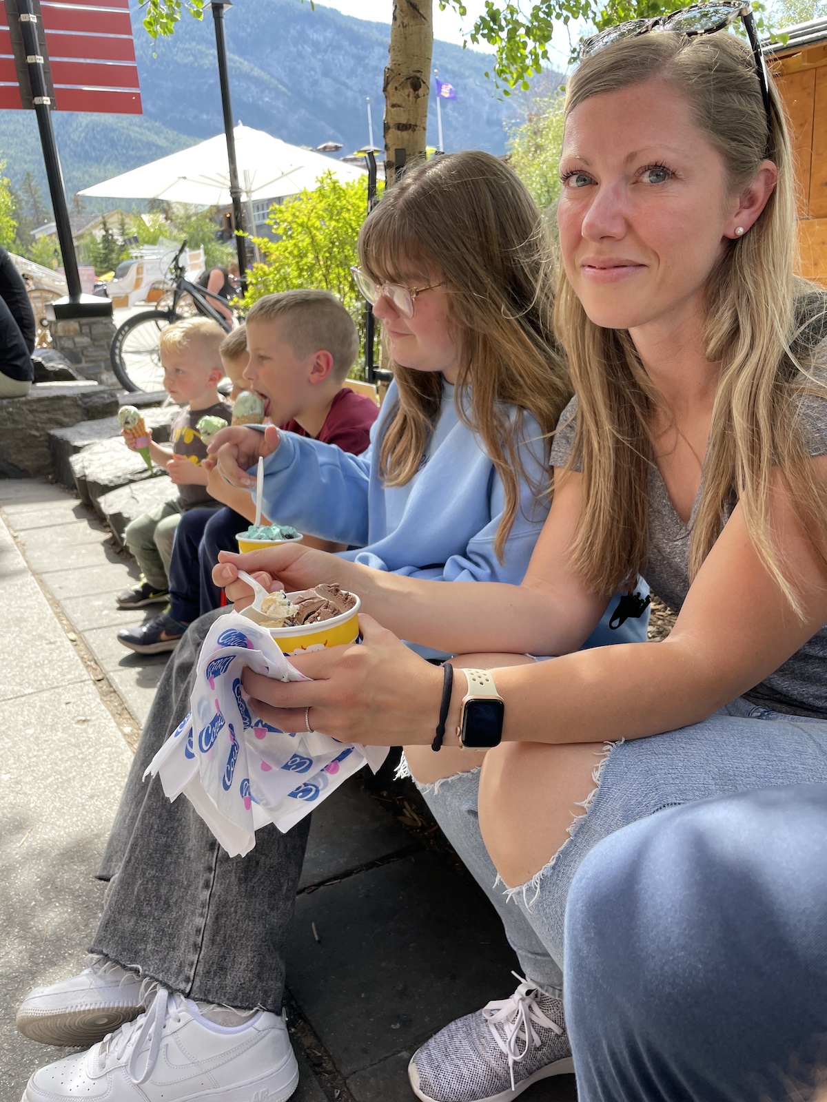 family sitting outside eating ice cream
